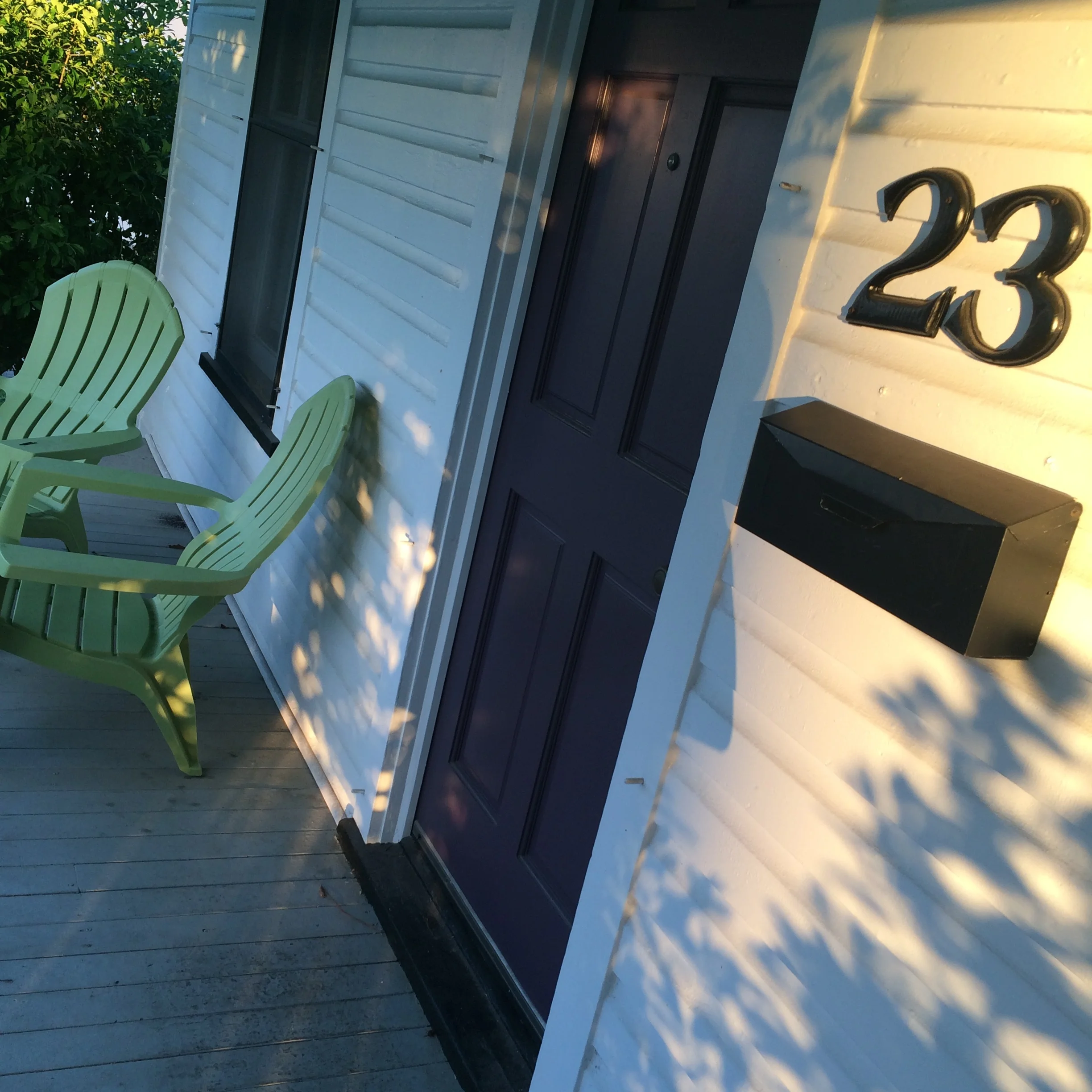 my purple door and green chairs and sunlight