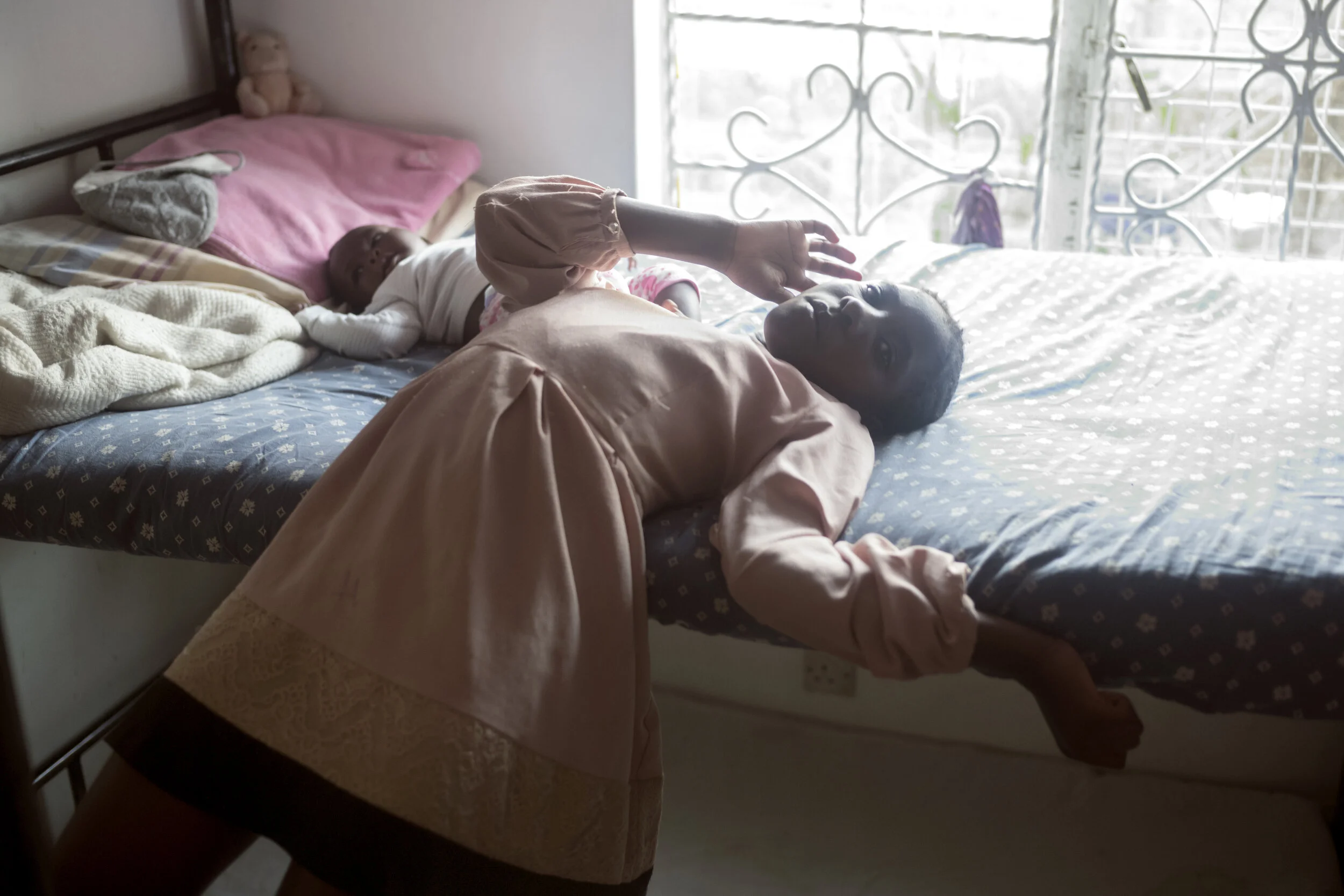  Agnes is looking after the baby girl Faith while her mother Selina is washing clothes. The girls look after each other's children when the mothers are working in the house or going to school. Faith is also the result of a rape.   