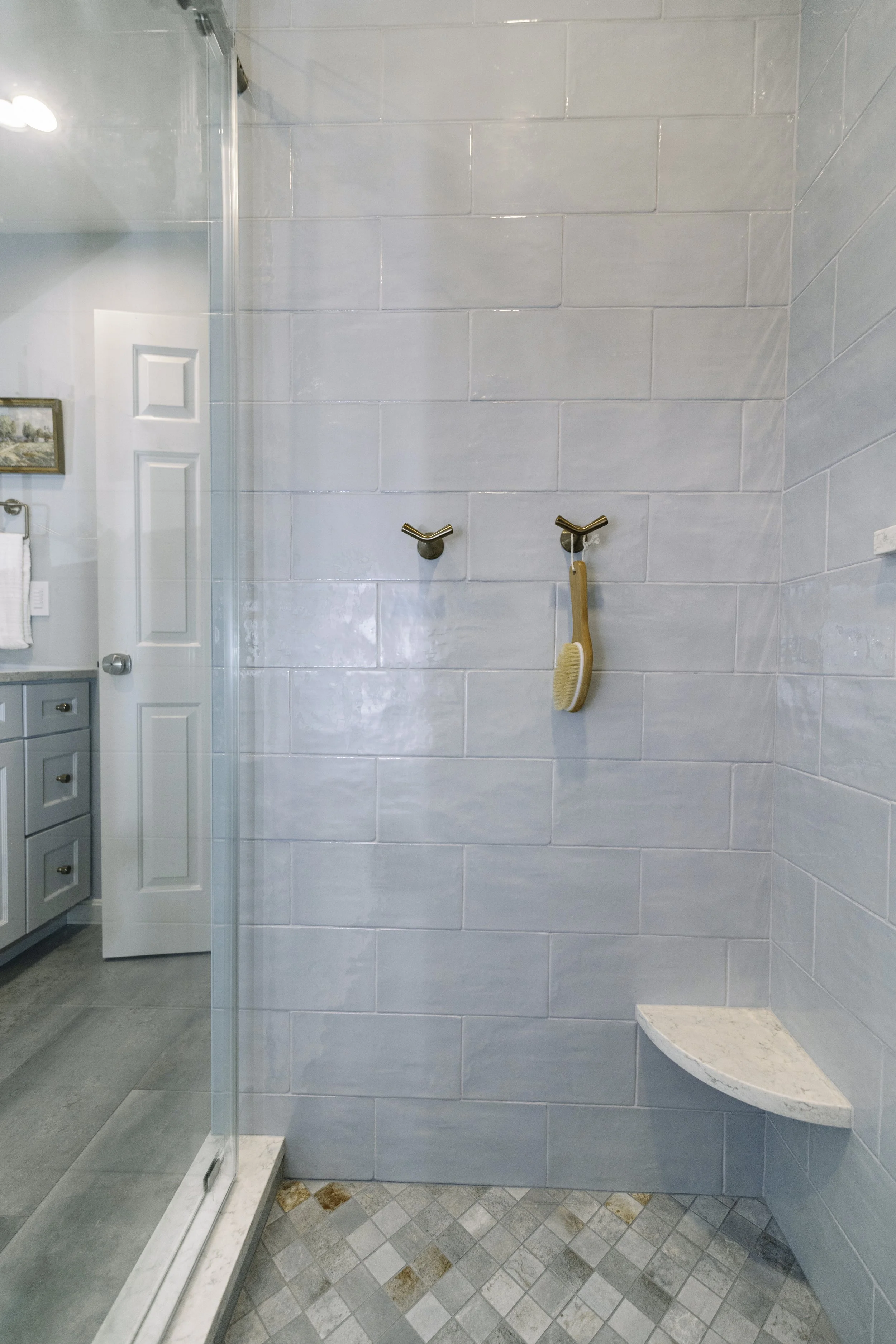 A guest bathroom with custom tile shower and new vanity