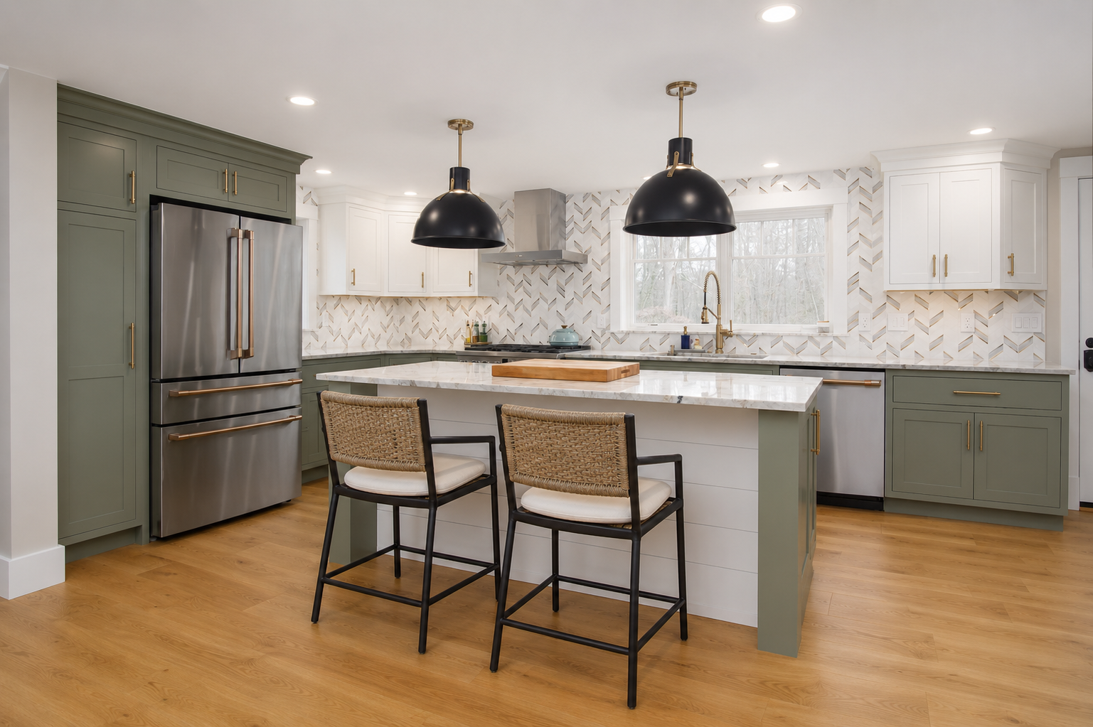 Beautiful kitchen with green and white cabinetry, oversized island, and custom lighting