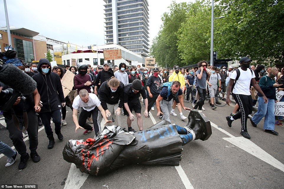 29476338-8409375-Black_Lives_Matter_protesters_roll_the_statue_along_the_street_t-a-87_1591875964769.jpg