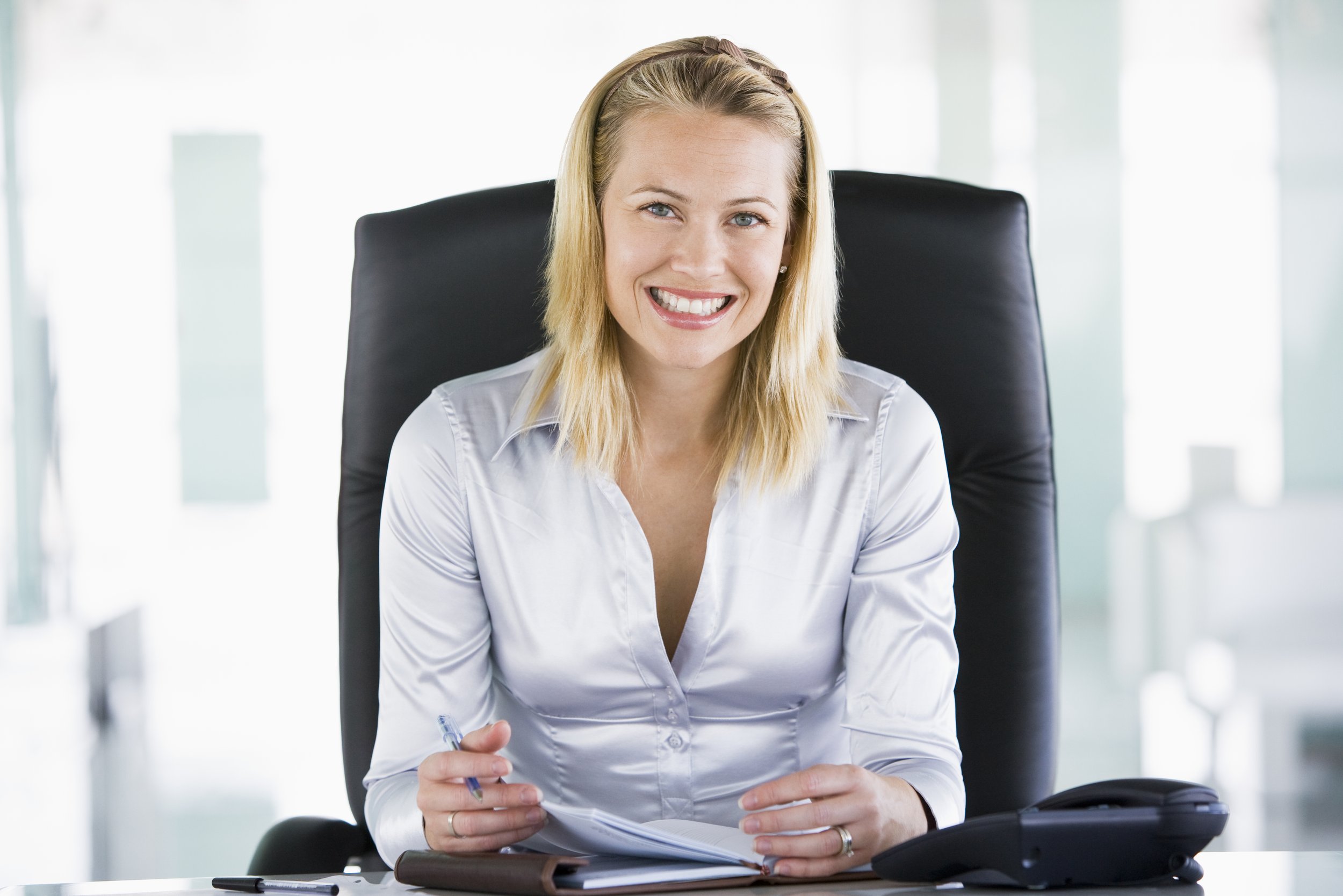 businesswoman-in-office-with-personal-organizer-smiling-SBI-301023044.jpg