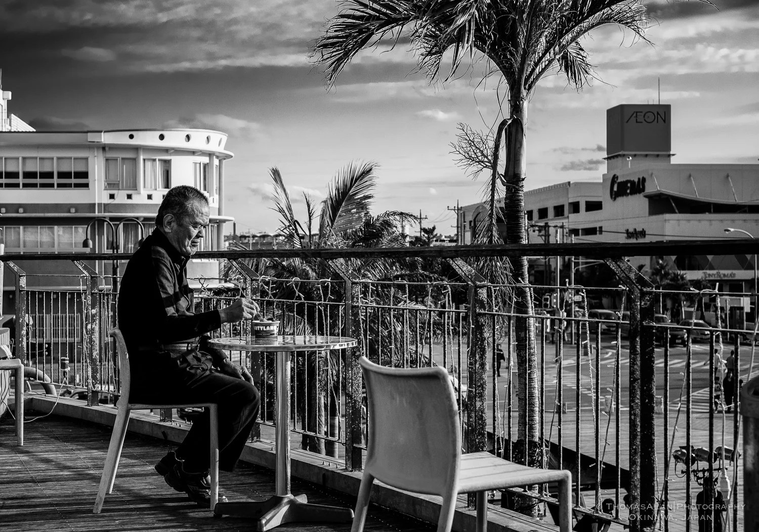 An old man eating ice cream in American Village, Chatan Okinawa.