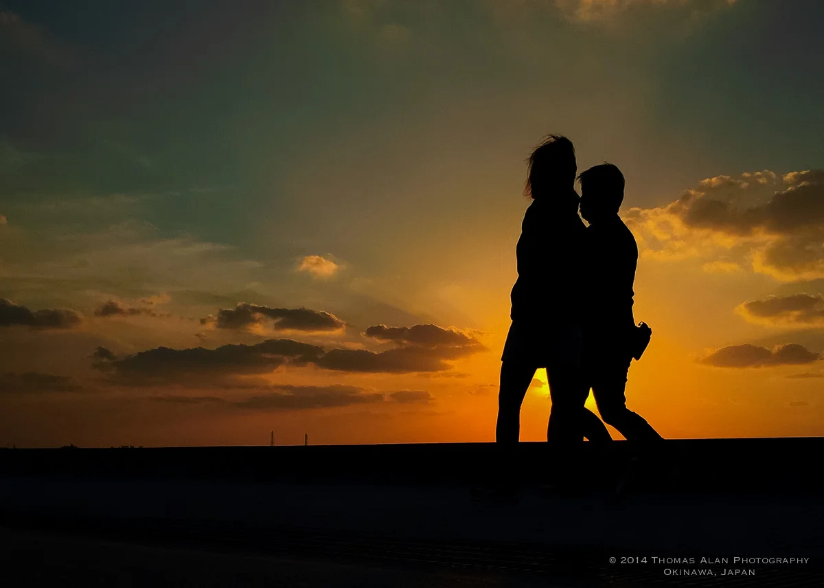 People walking on the beach in Chatan, Okinawa enjoying the last sunset of 2014.