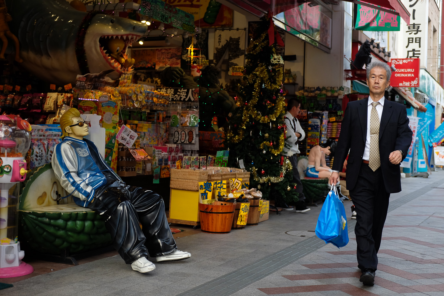 A businessman walking on Kokusai street in Naha, Okinawa.