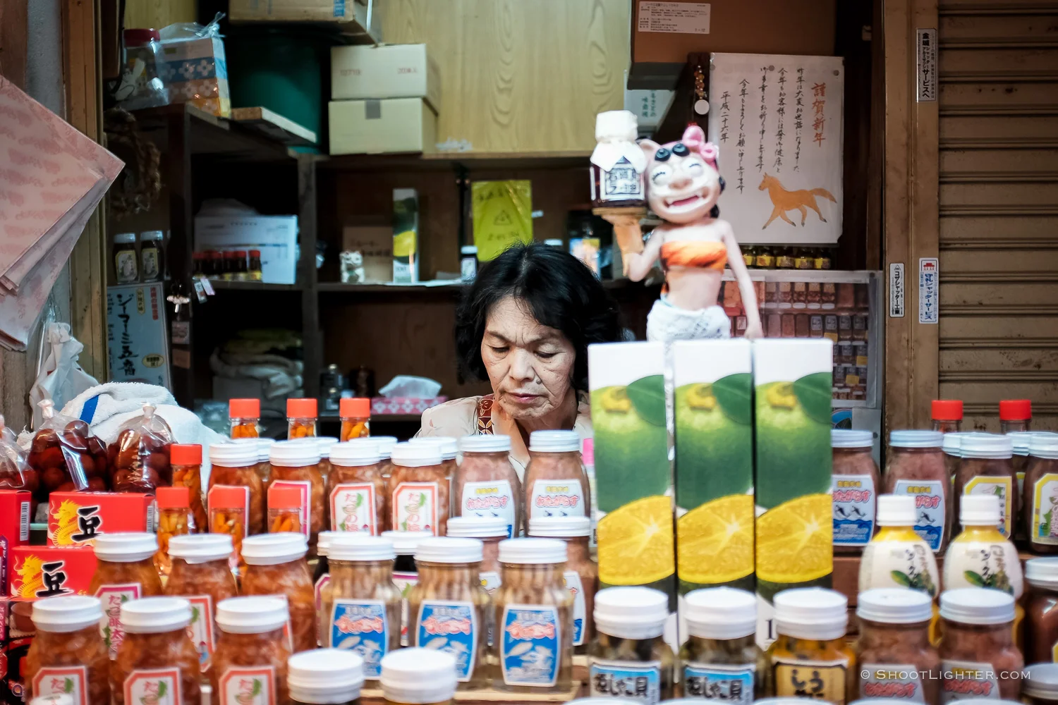 An Okinawan lady sells various jarred pickled products in Naha, Okinawa Japan. Fuji film x100T, ISO 320, f/2.0, 1/60 sec, Fujifilm c hrome film emulation, edited in Adobe Lightroom 6.