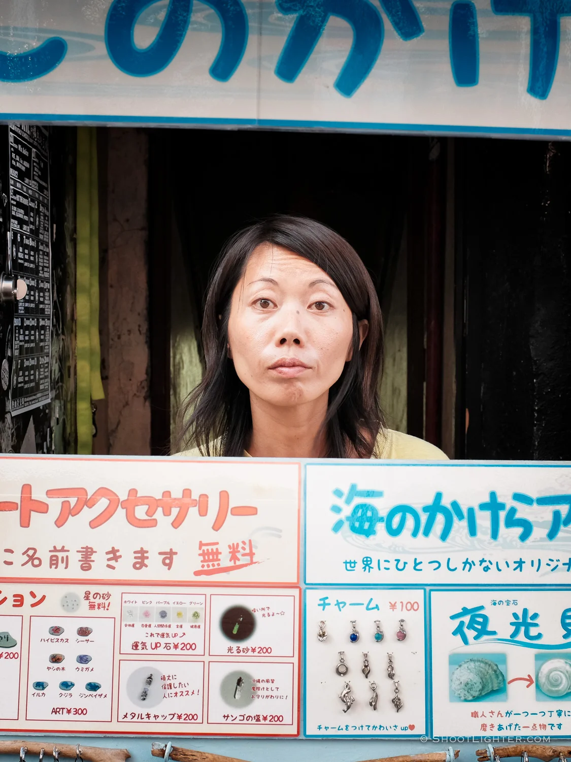 Woman manning a small jewelry shop on Kokusai street in Naha, Okinawa Japan. Fujifilm x100T, ISO 400, f/5.6, 1/110 sec, Fujifilm chrome film emulation, edited in Adobe Lightroom 6.