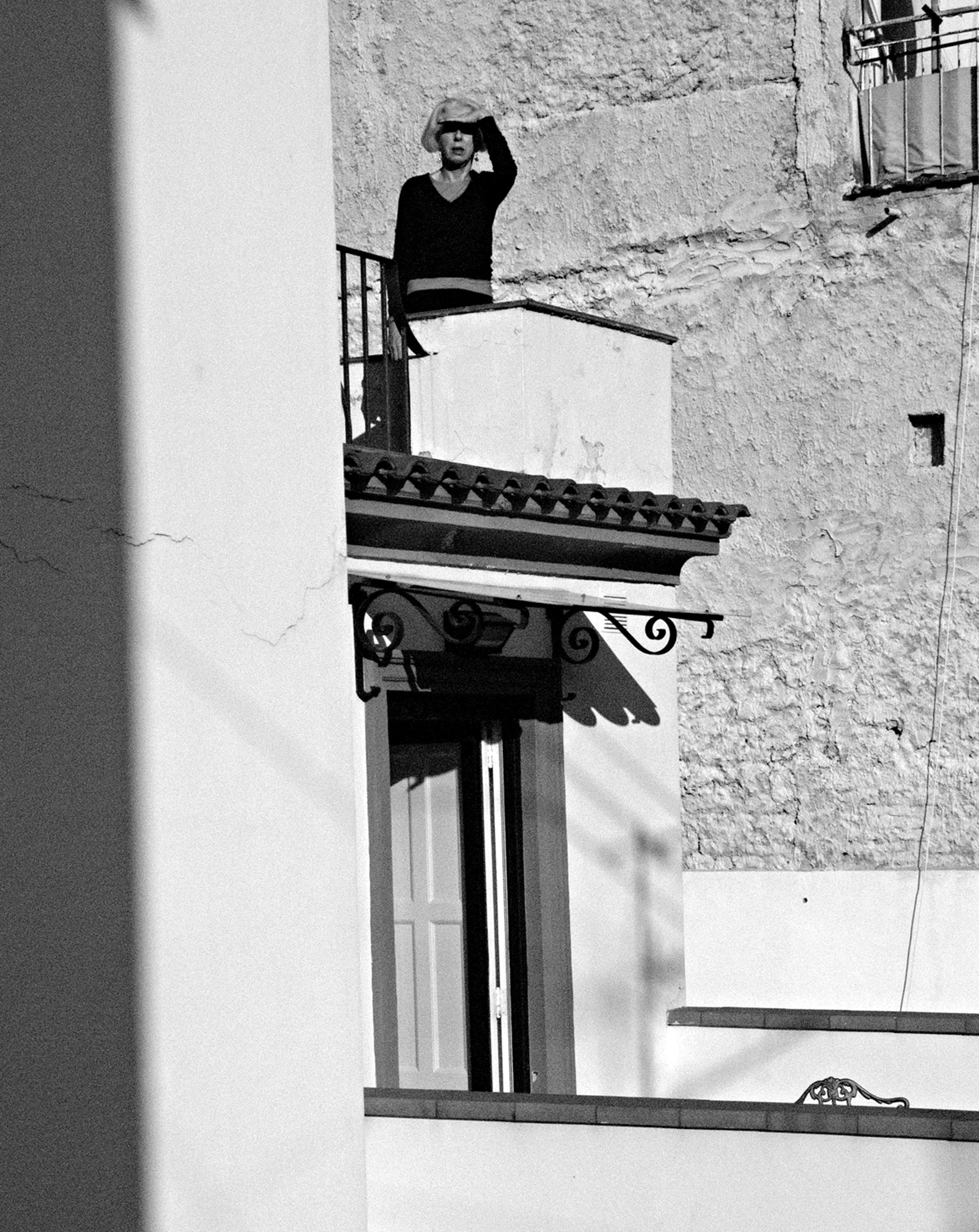 Woman on balcony, Amalfi, Italy. 