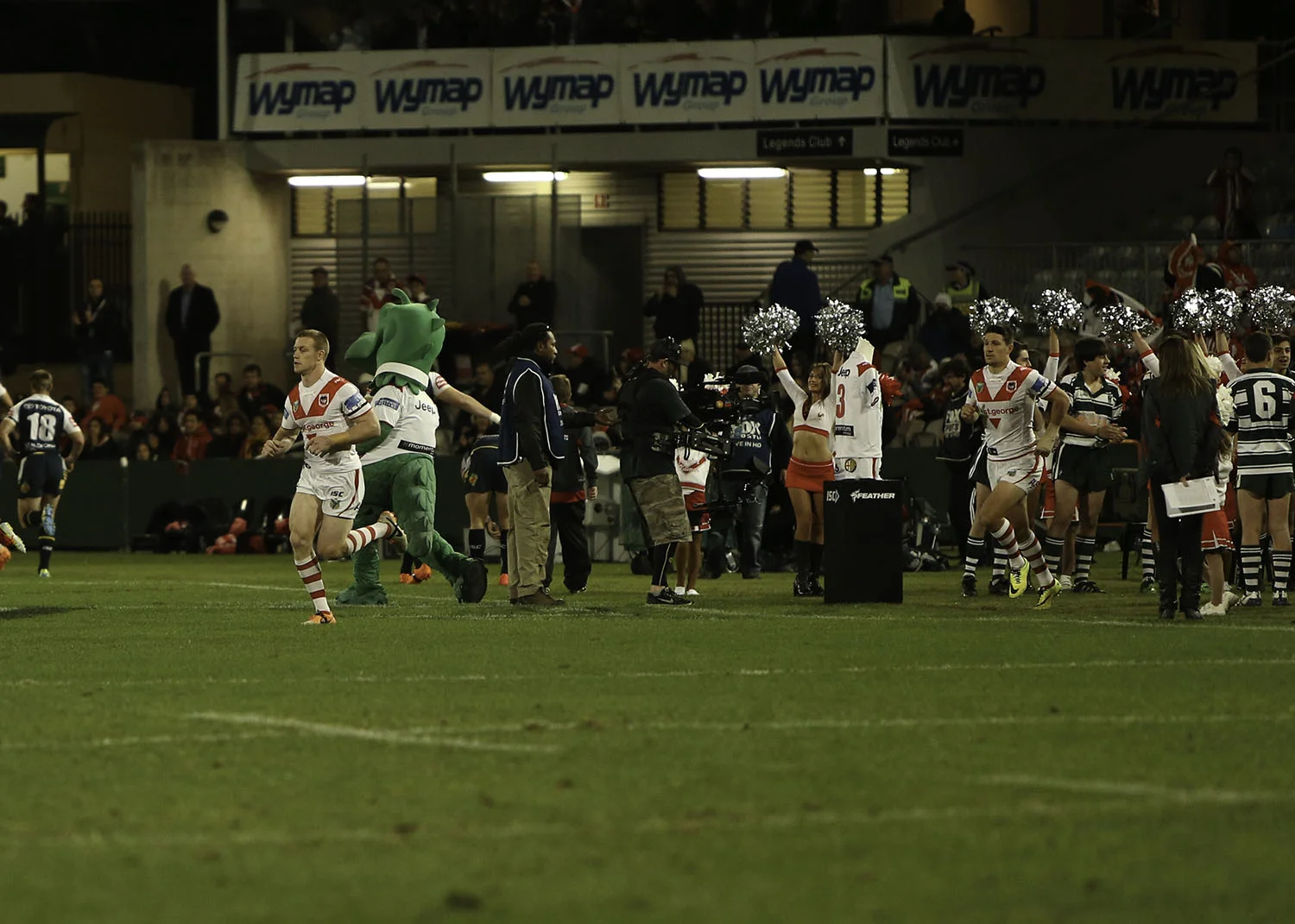 Ben Creagh leading the Dragons out and running past the retired Reg Gasnier no.# jersey