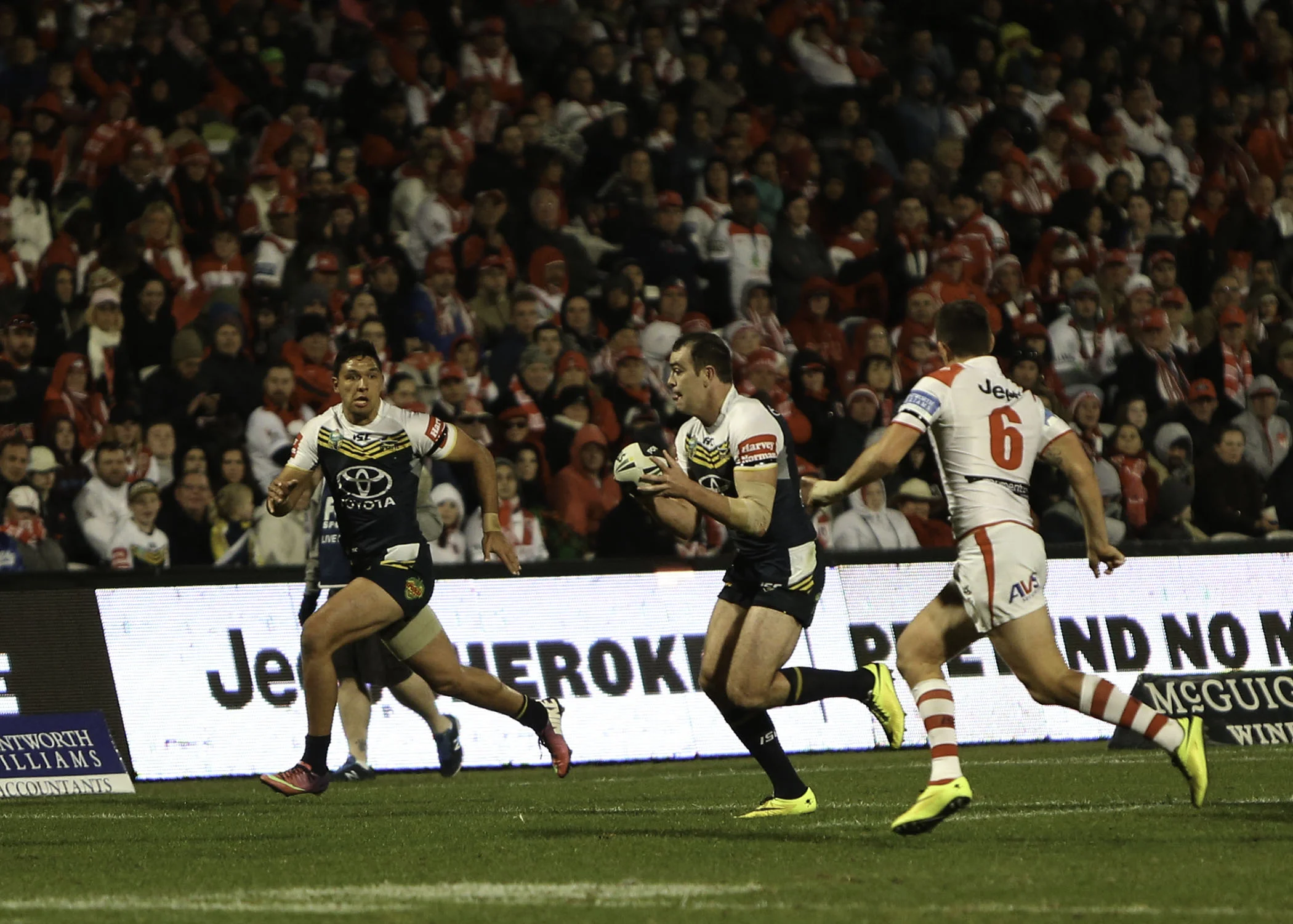 Another junior Dragon, Kane Linnett trying to find space for his winger