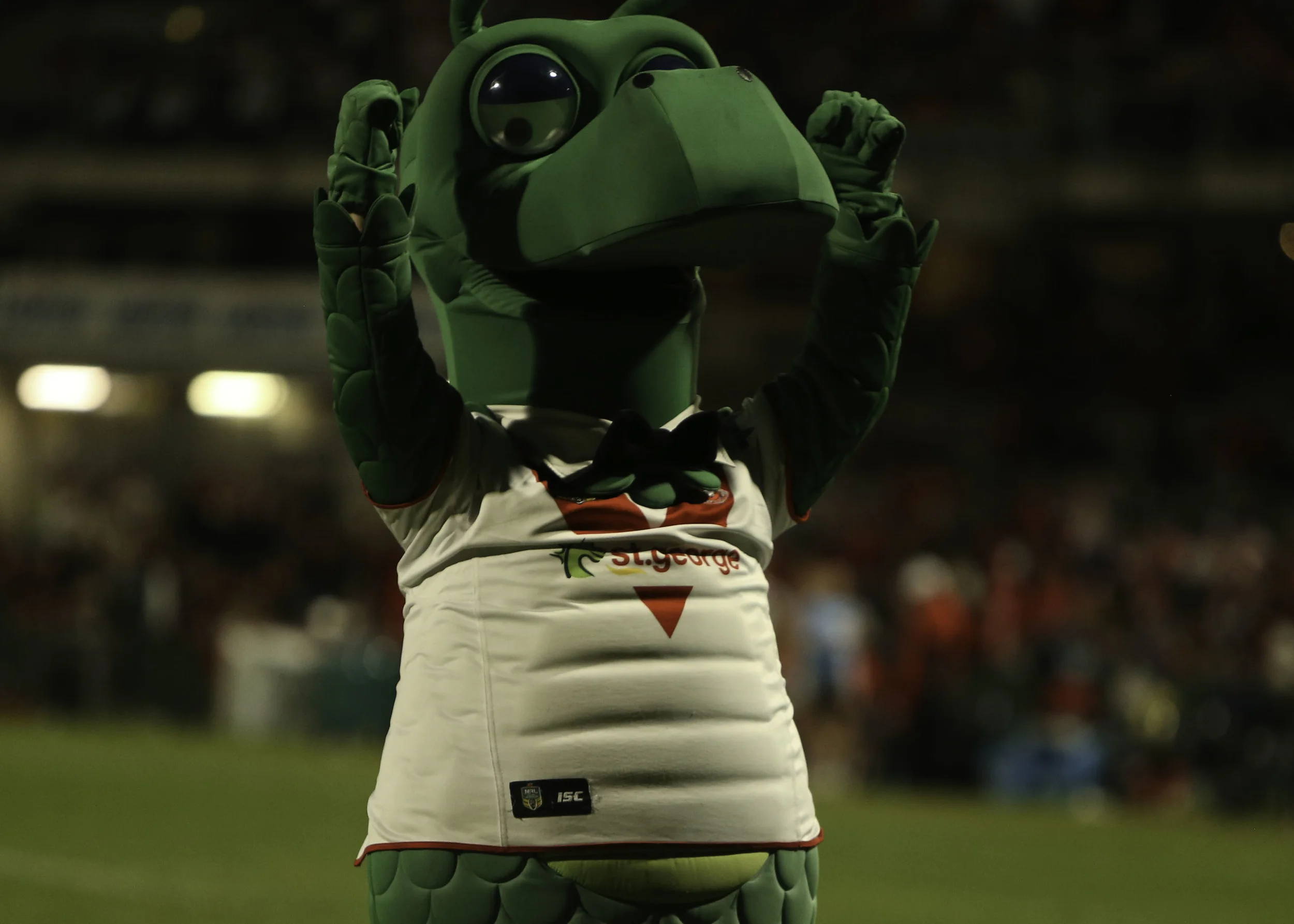 The defiant Happy Dragon mascot .. gives the crowd a fist pump after Widdop kicks a field goal to make it 27-20 with less than 10 mins on the clock