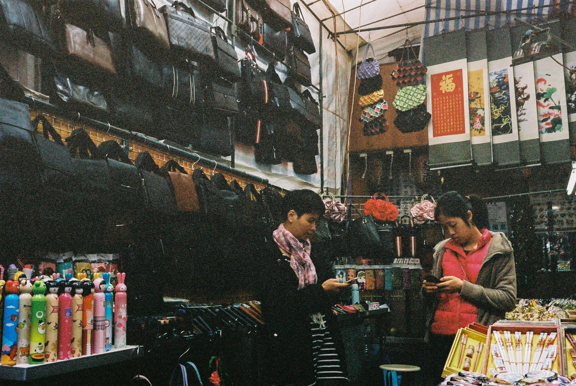 How business is done in Lady's Market. Pay pal payment ? or just a slow day and the shop keepers are helping each other in Candy Crush?  Kodak Portra 400, Leica M6 with Voigtlander Wide Angle Color-Skopar Pan 35mm f/2.5-M (PII)