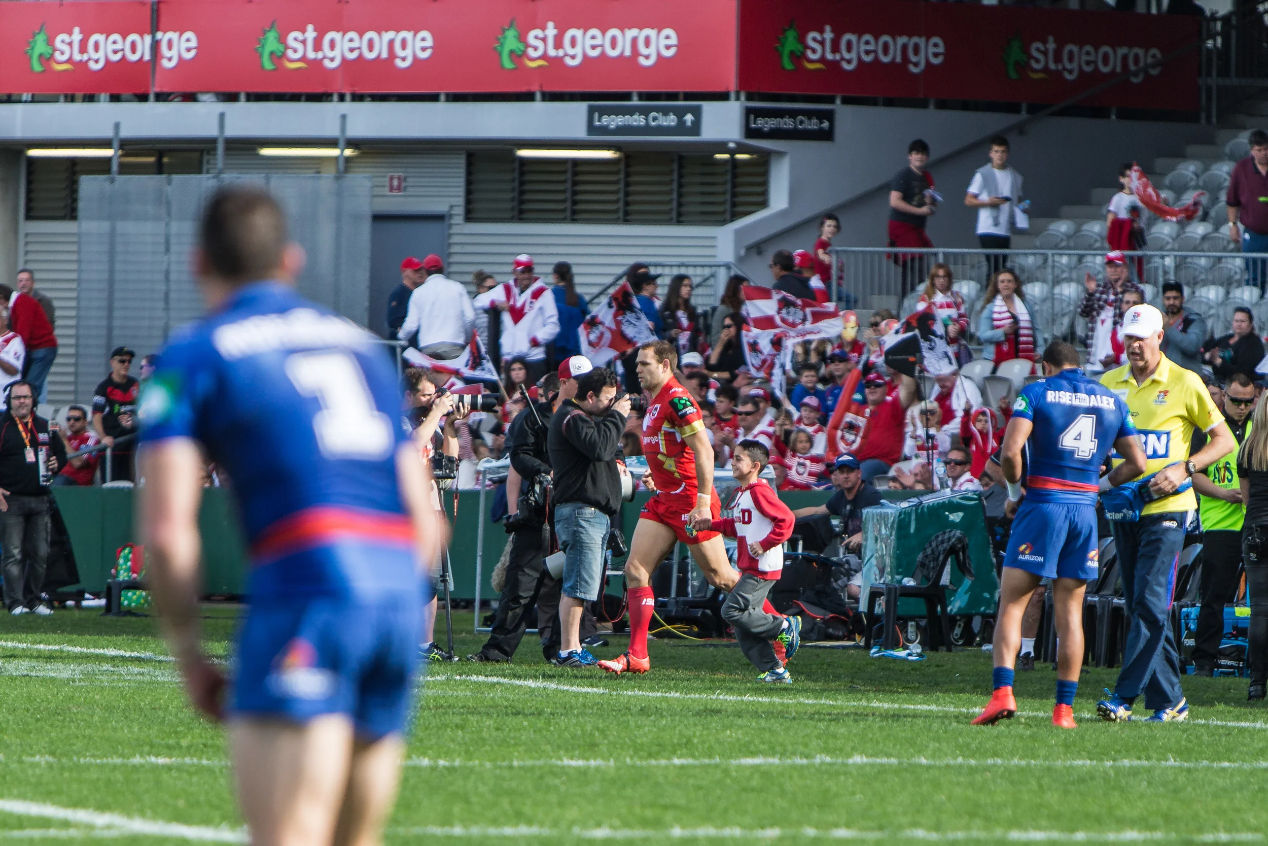 Opposing captains, Gidley in the No.1 and Jason Nightingale leads the Dragons out