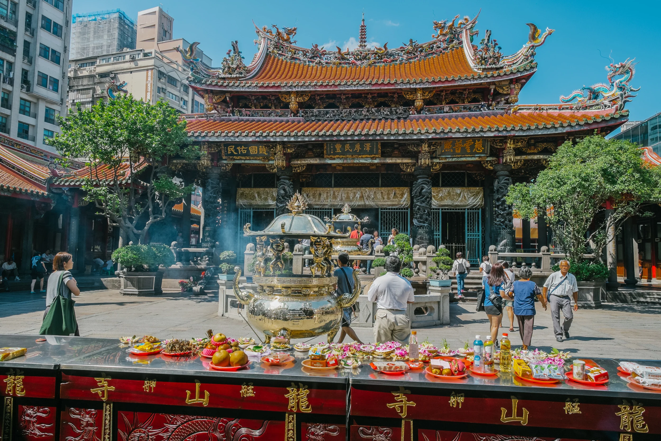 Lungshan Temple, people bring fruits and burn incense for Buddha