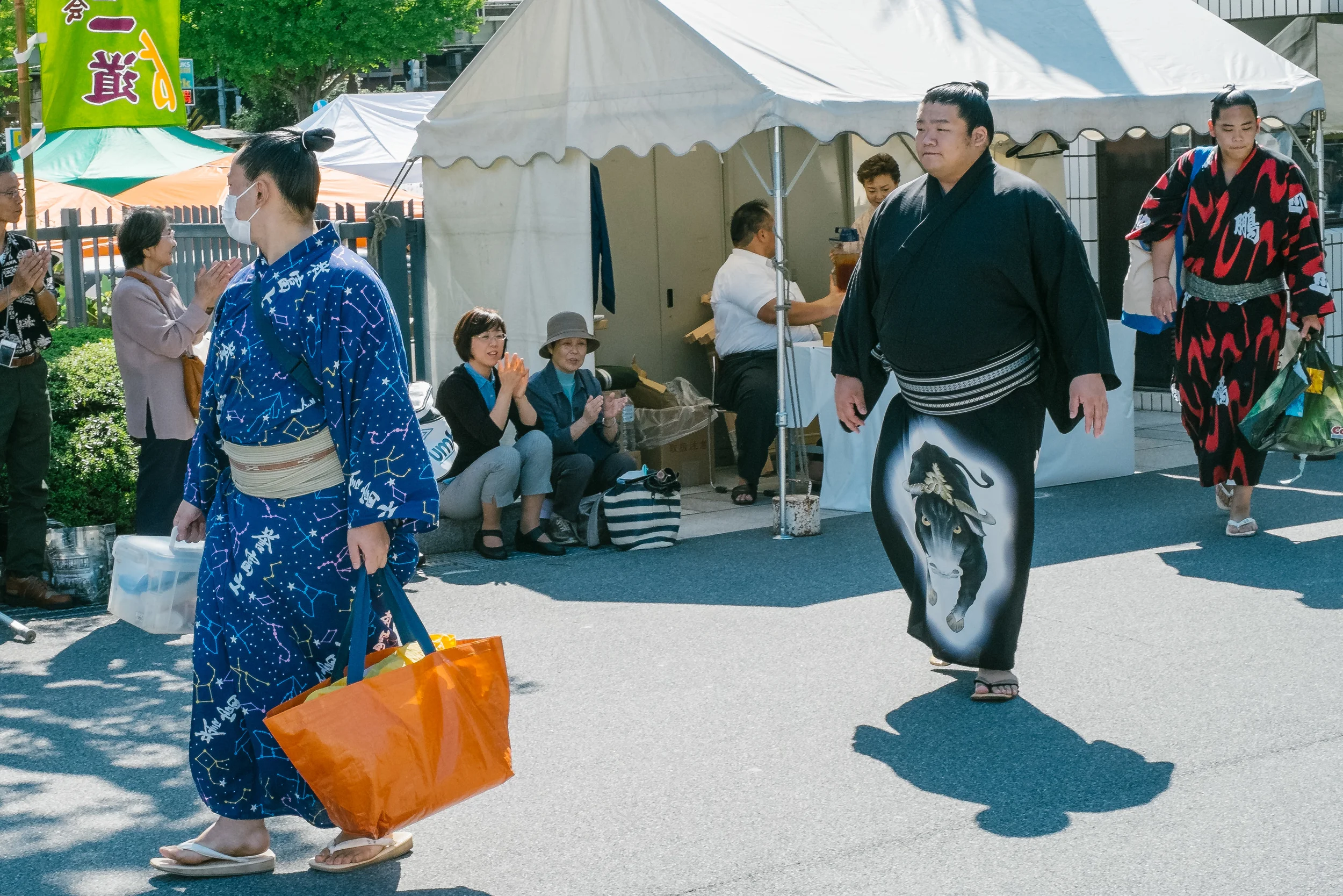 Someone needs to tell him he will standout even without the orange bag !