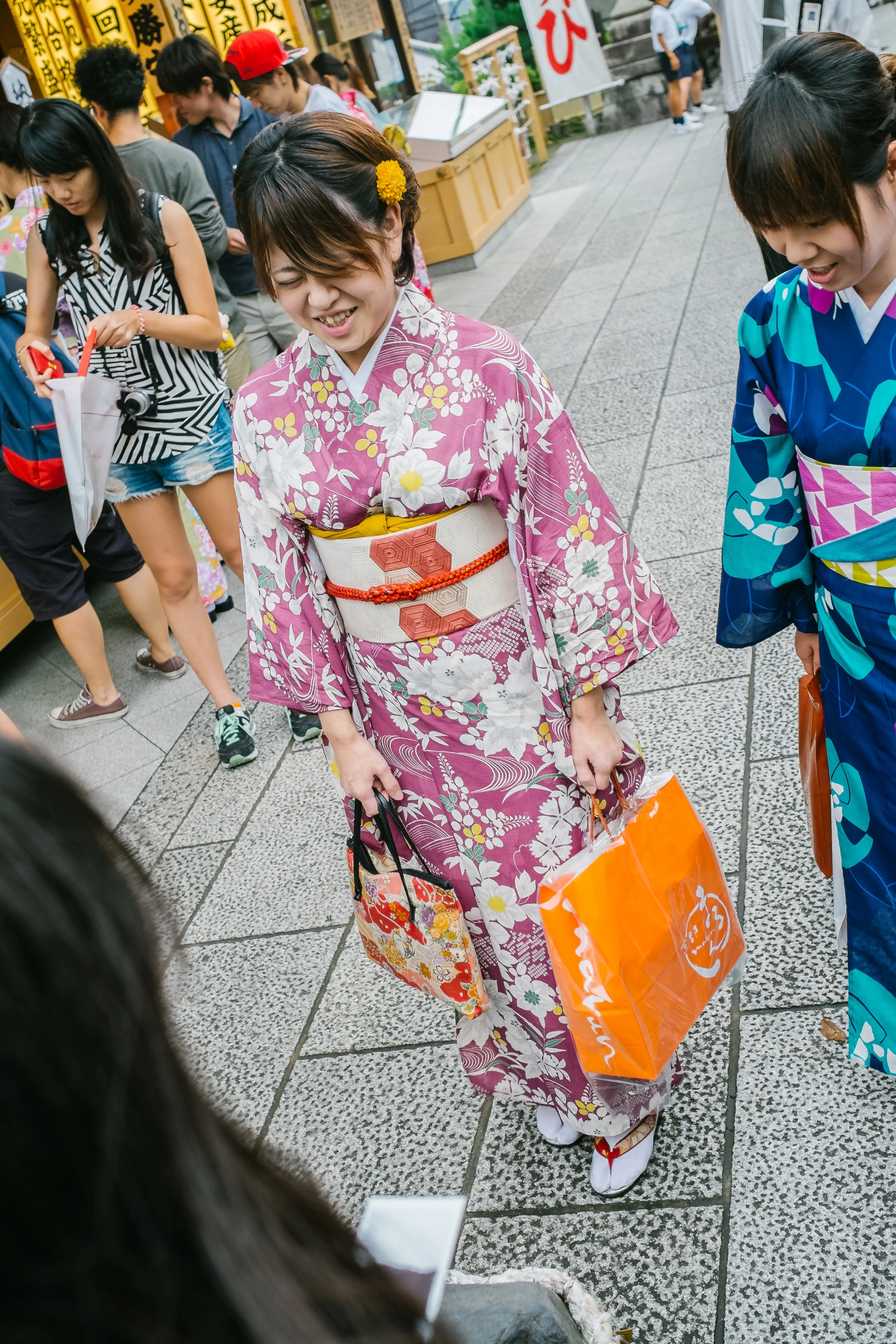 A young Japanese girl attempting to walk the 20 paces to make sure her wedding wish comes true. Let's just hope she is just practicing. This is found in the matching making shrine