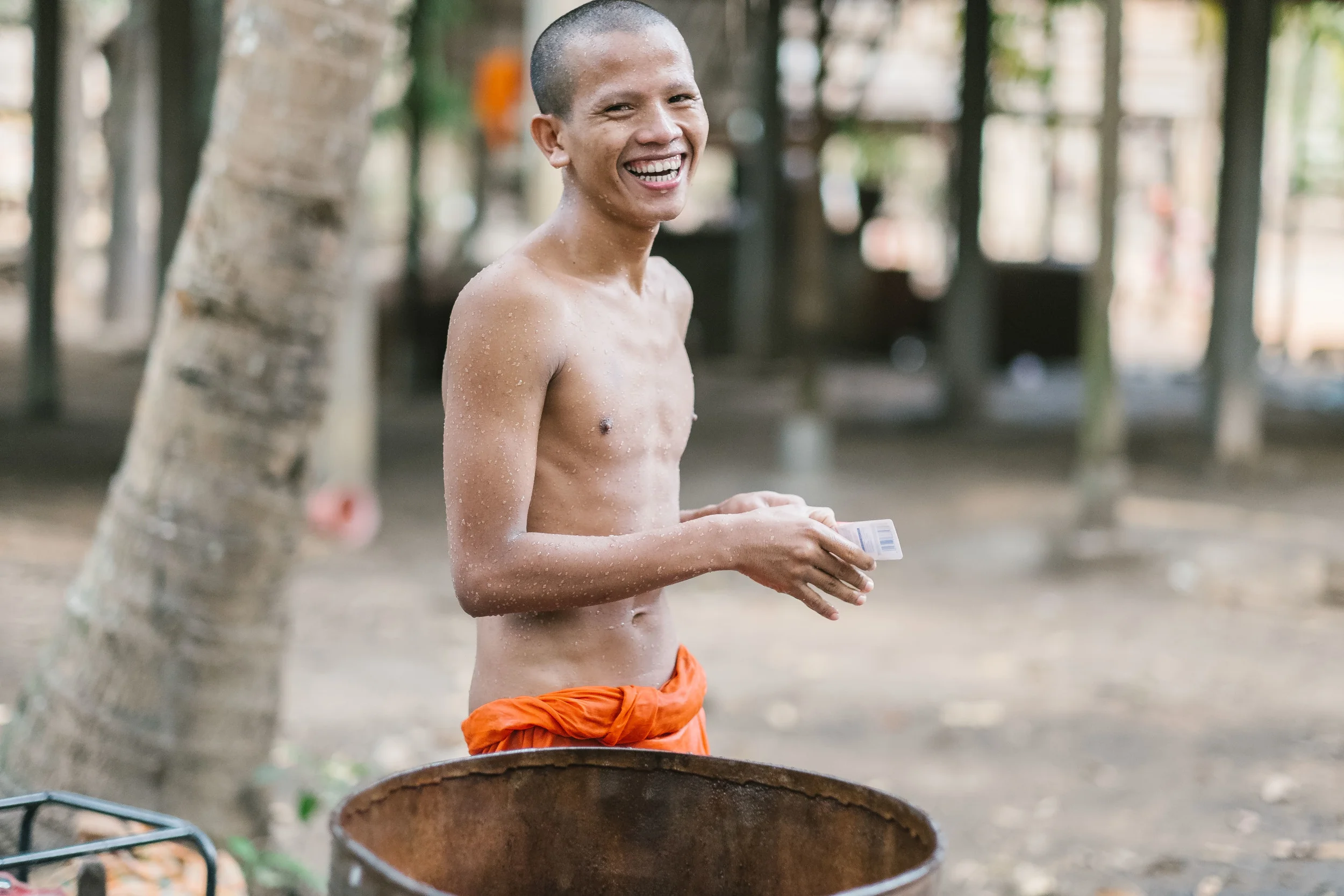 A young monk was willing to pose for a few photos as he scrubbed himself clean  Fuji X-Pro 1, 56mm f/1.2 R