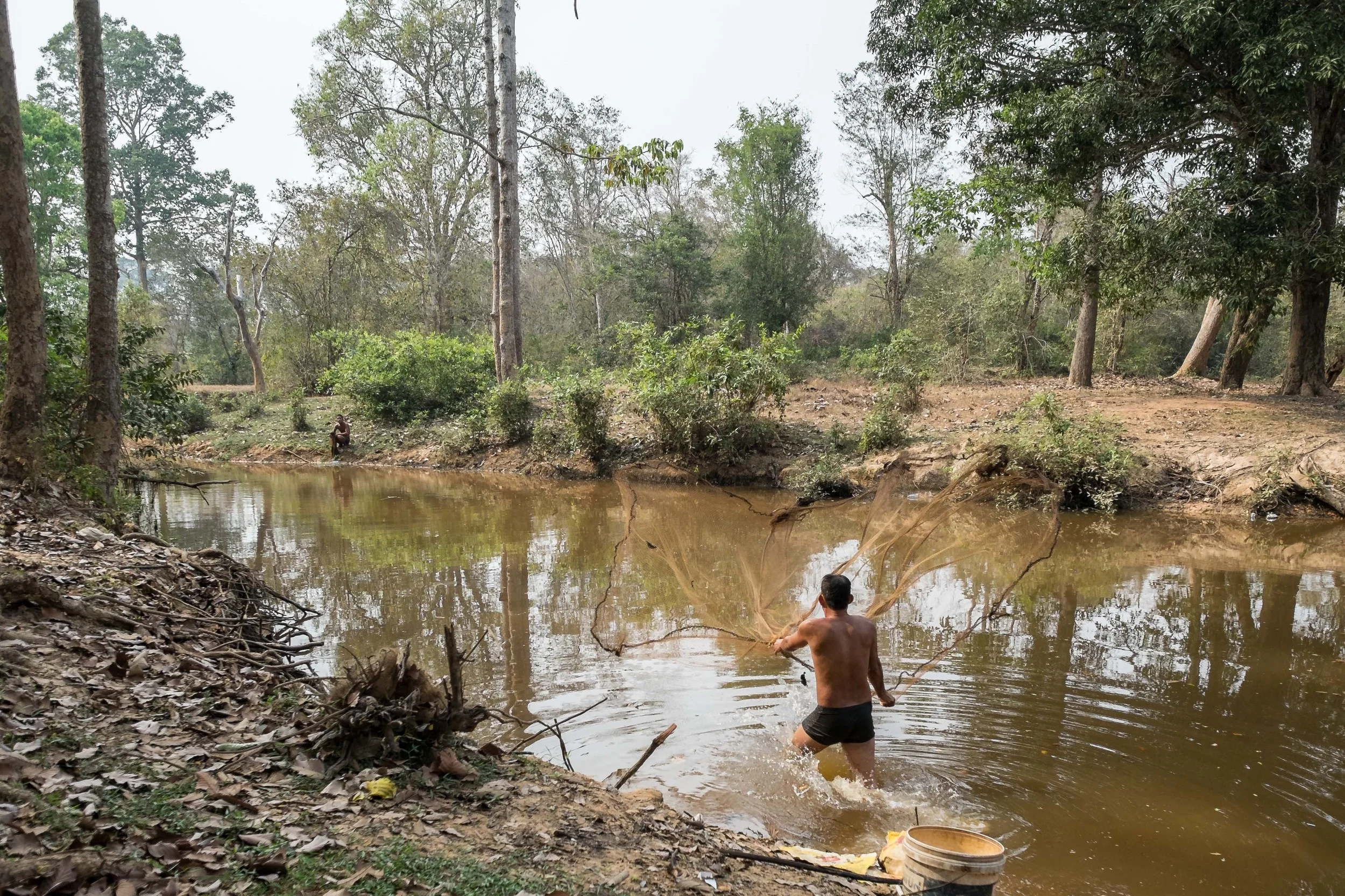 Local fisherman trying to find a feed tonight. The fish he caught were no more than 3 inches long.&nbsp; Fuji X-Pro 1, 14  mm f/2.8