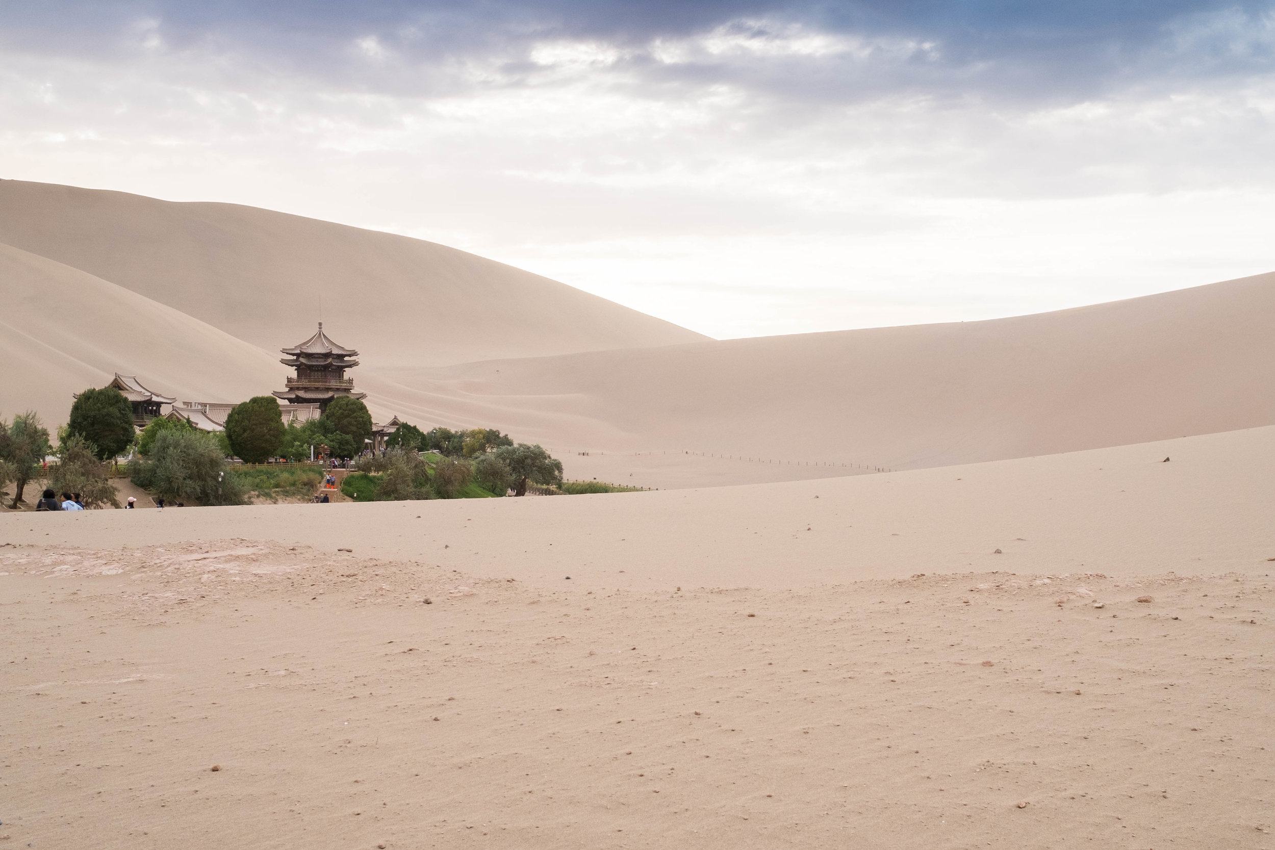 Crescent Moon Lake is obscured by the sand