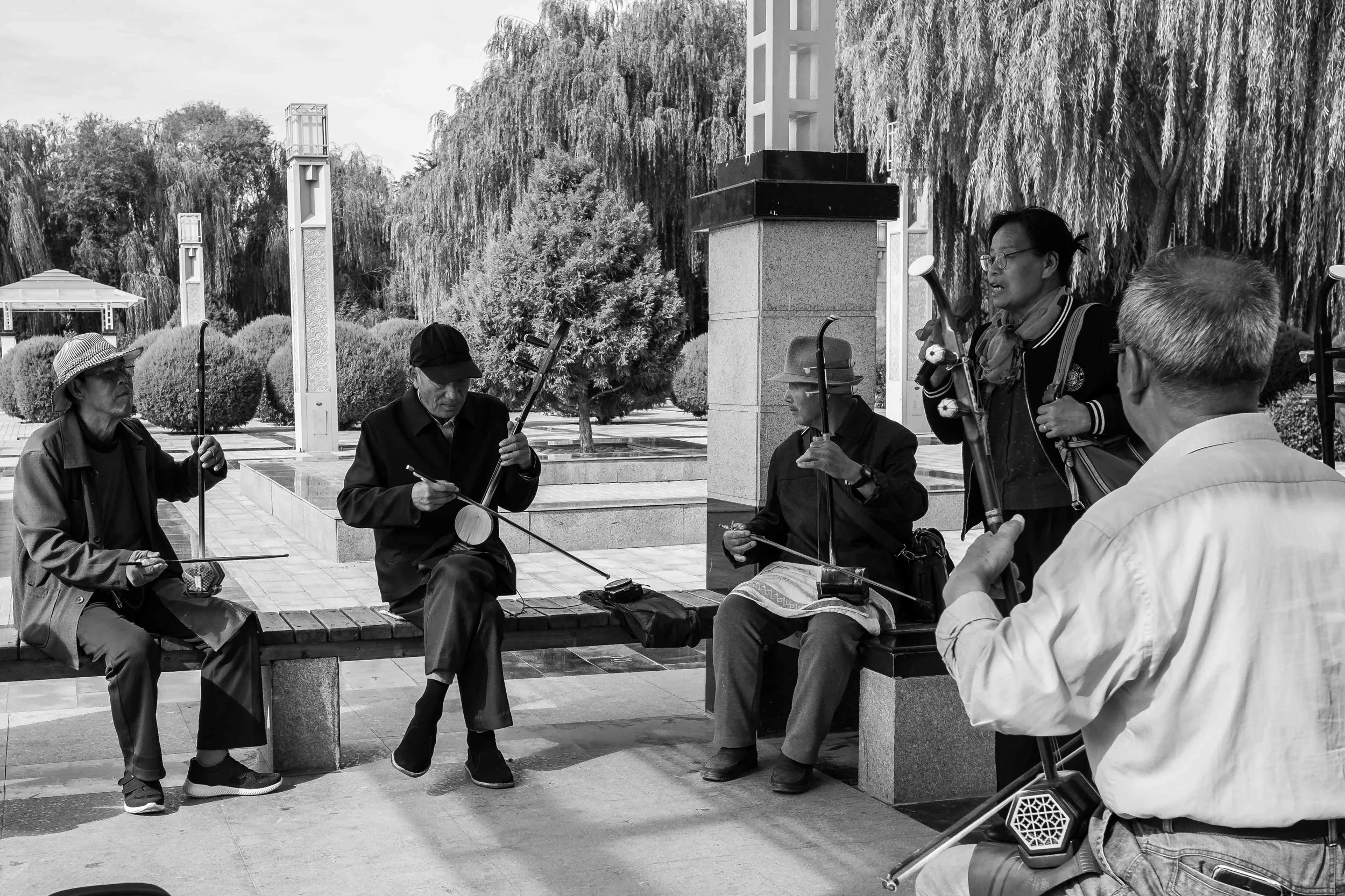 Retired people now enjoying their lives. Jiayuguan city garden