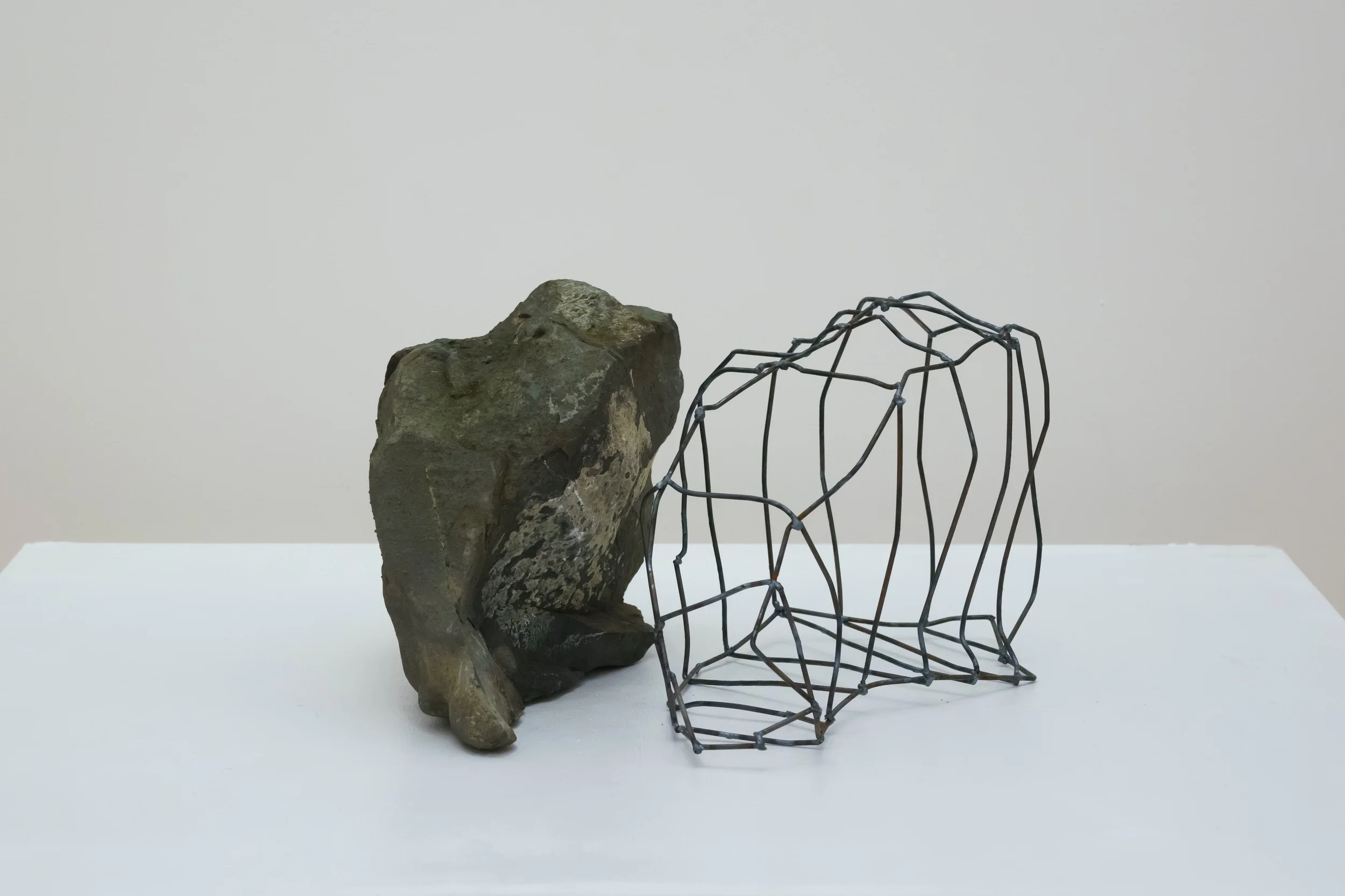 Rock Cage: Let Go , 2015 Steel, Fieldstone, 10" x 17" x 18"