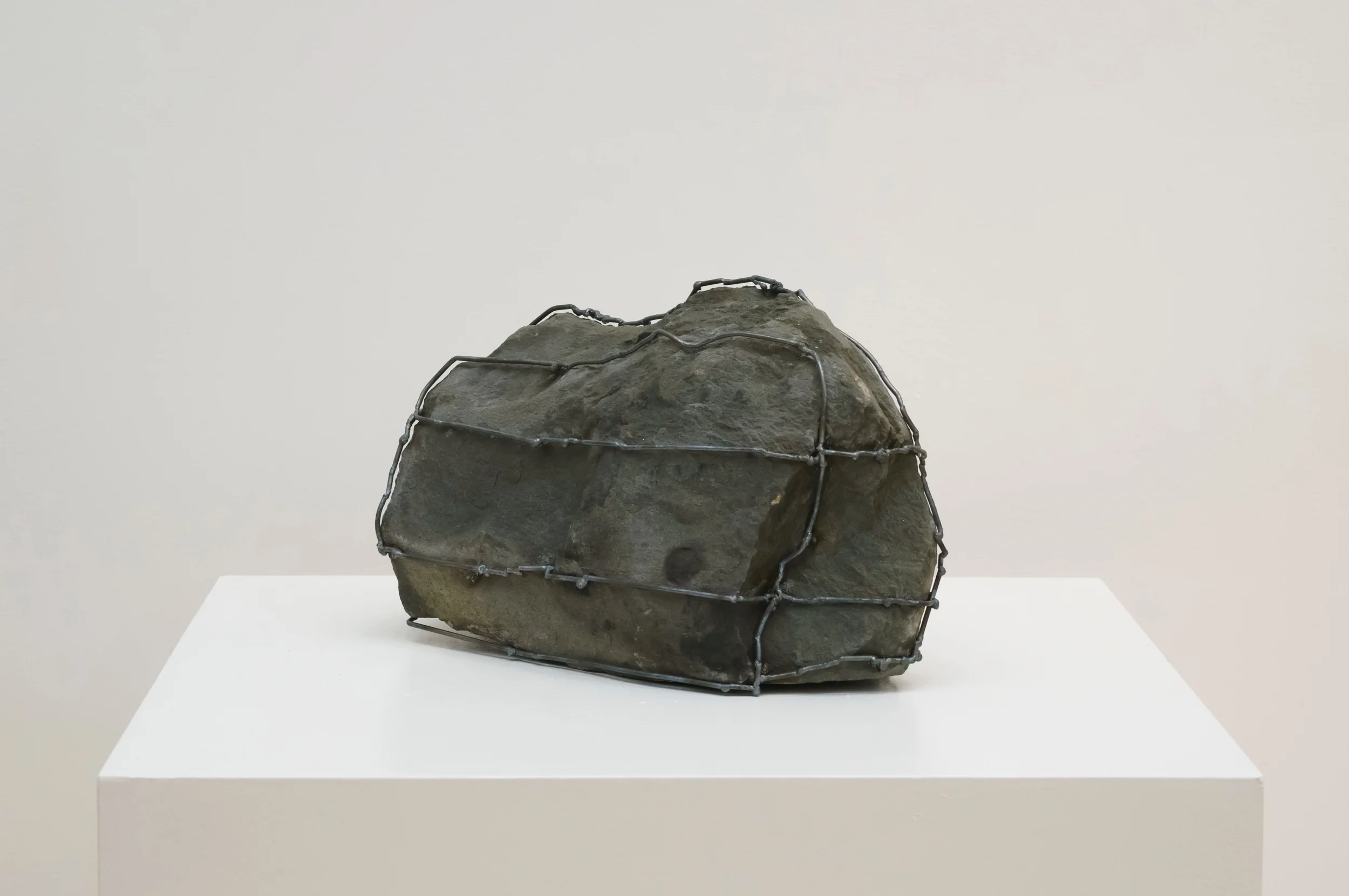 Rock Cage: Hold On, 2015 Steel, Fieldstone10" x 16" x 17"