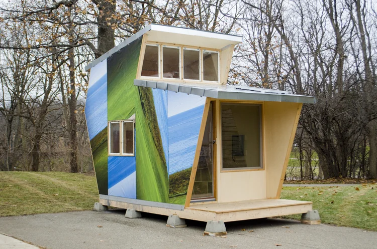 The 80 square foot multi-storied dwelling is wrapped in weatherproof recycled billboard. When speaking with members of the homeless community, safety was their most important concern. Lofting the bed became Outlook’s defining feature.