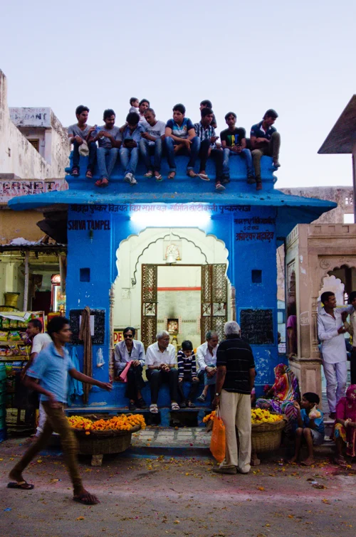People grab a good spot as the main chowk starts to get lively