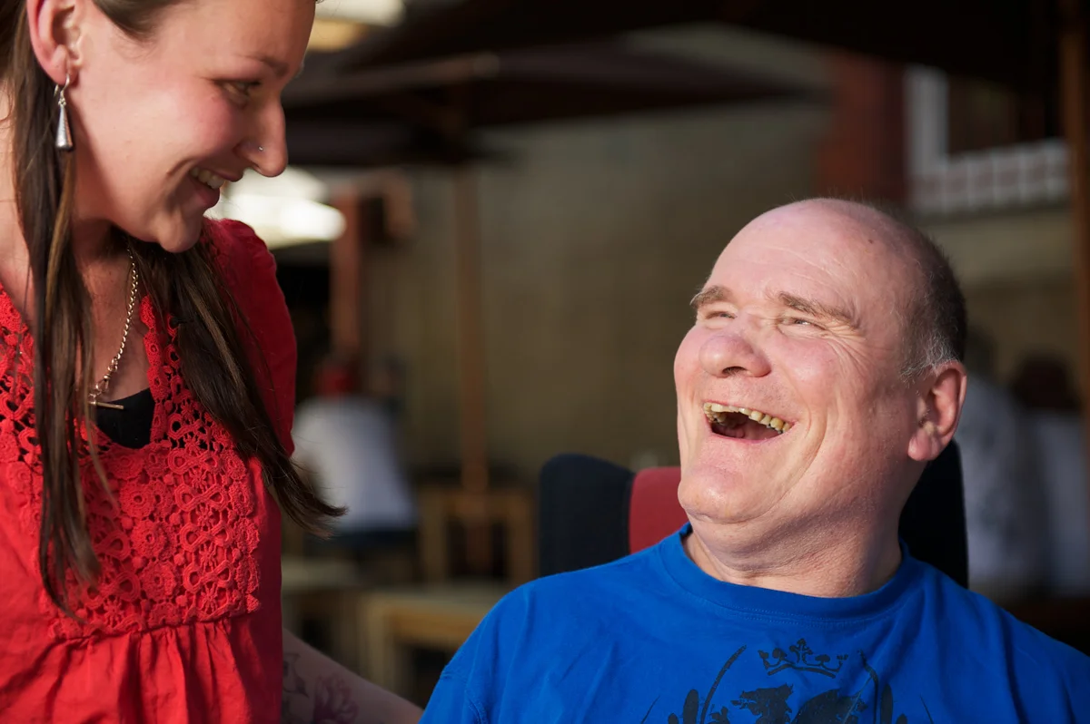 20100312-man with a disability laughing with woman at cafe-2.jpg