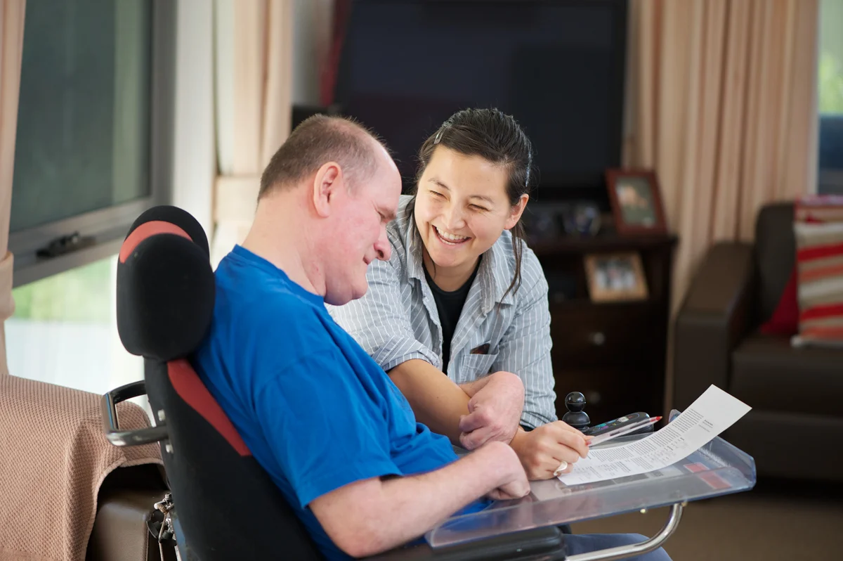 20100819-staff member smiling with a man in an electic wheelchair.jpg