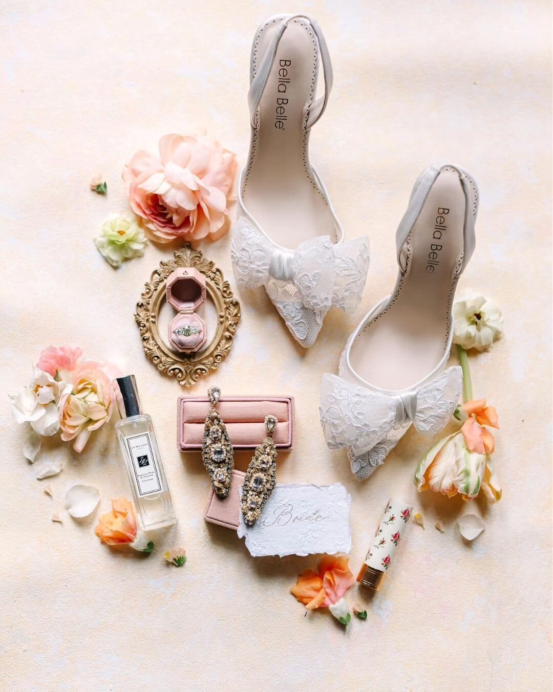 The Fontainebleau Earrings, captured by @hannahwayphoto in this pretty arrangement of bridal details. These ornate wedding earrings are adorned with gilded handmade lace motifs and sparkling vintage crystals. ⁠
⁠
Made in our Vermont, USA, atelier and