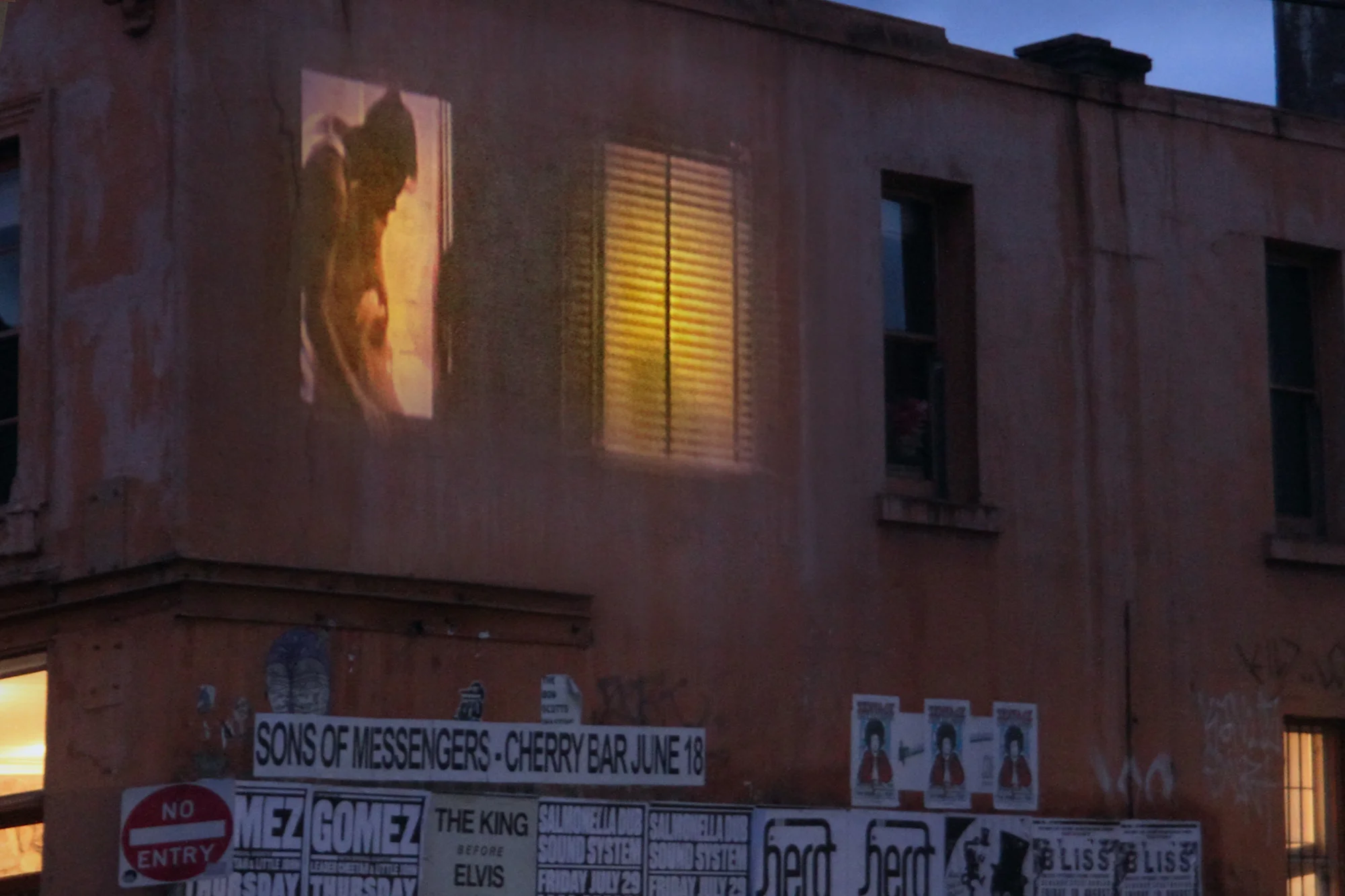 Vertigo in time , is a site projection of eerie shadows and back lit figures looking out of windows. The film uses repeated and slowed excerpts form Rear Window (1954). The building was a boarding house and was derelict until the early 1990's when it was occupied by artists and students. The work was projected onto concreted windows on the corner of little Smith Street lane and Gertrude Street Fitzroy, Melbourne.