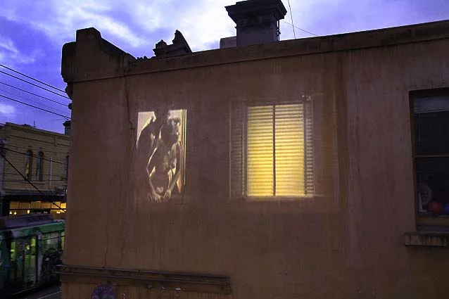 Vertigo in time , is a site projection of eerie shadows and back lit figures looking out of windows. The film uses repeated and slowed excerpts form Rear Window (1954). The building was a boarding house and was derelict until the early 1990's when it was occupied by artists and students. The work was projected onto concreted windows on the corner of little Smith Street lane and Gertrude Street Fitzroy, Melbourne.