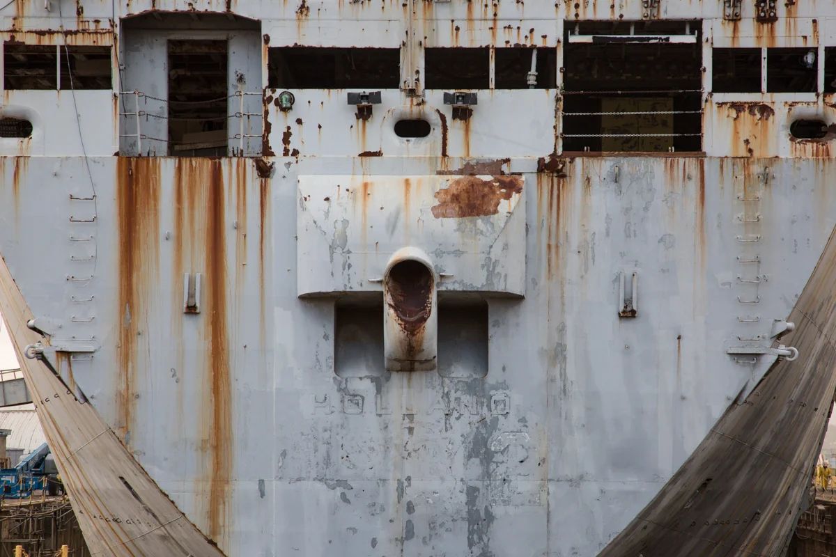 The ship name has faded since being moored in the Fleet 