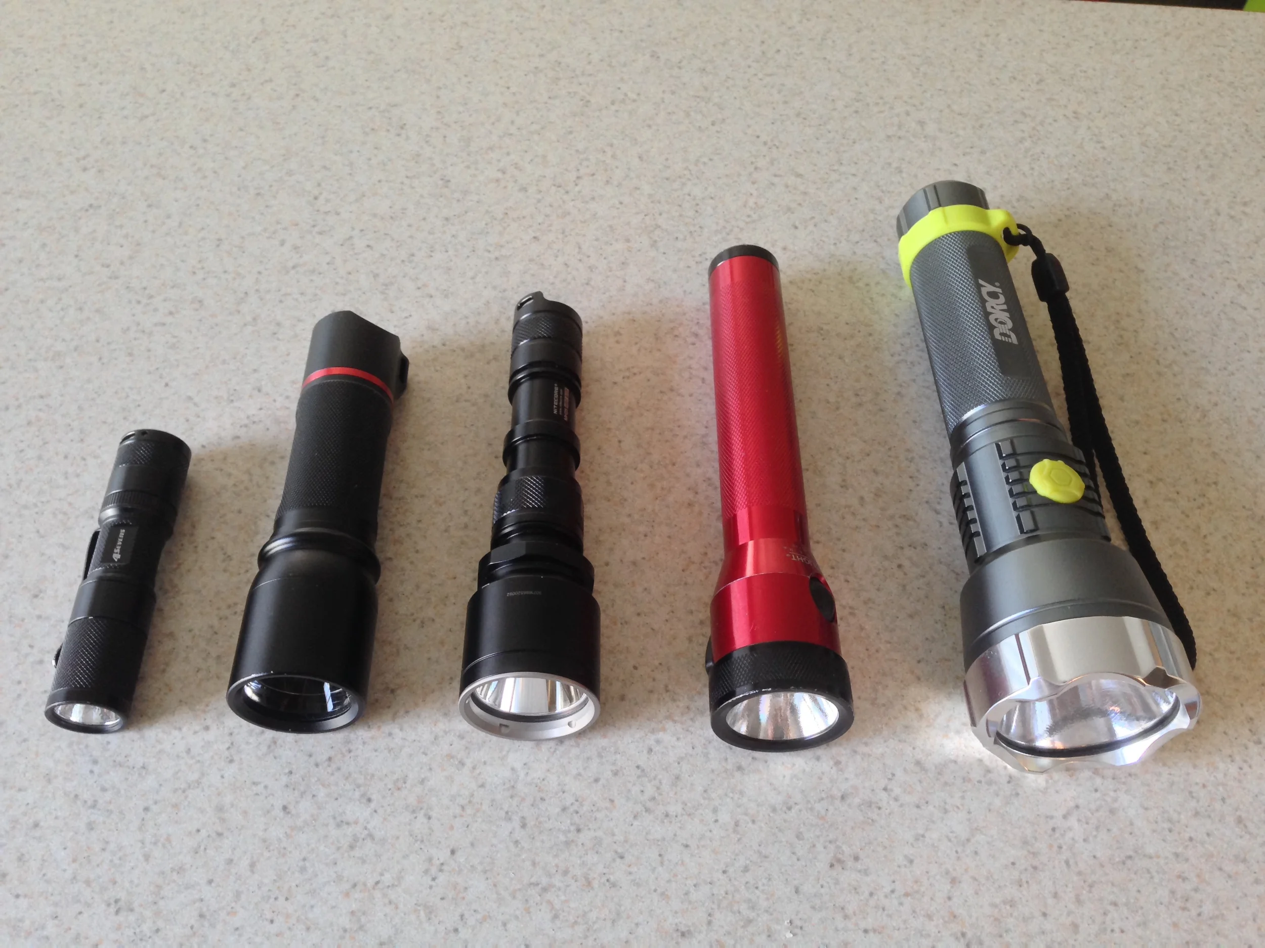 Left to right: 4Sevens Quark AA tactical, Coast HP7, Nite Core MH25 Night Blade, Streamlight Stinger, Dorcy Metal Gear XL-M 