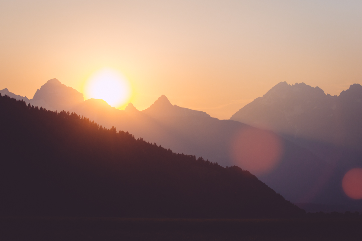 Sun setting while driving through the Grand Tetons 
