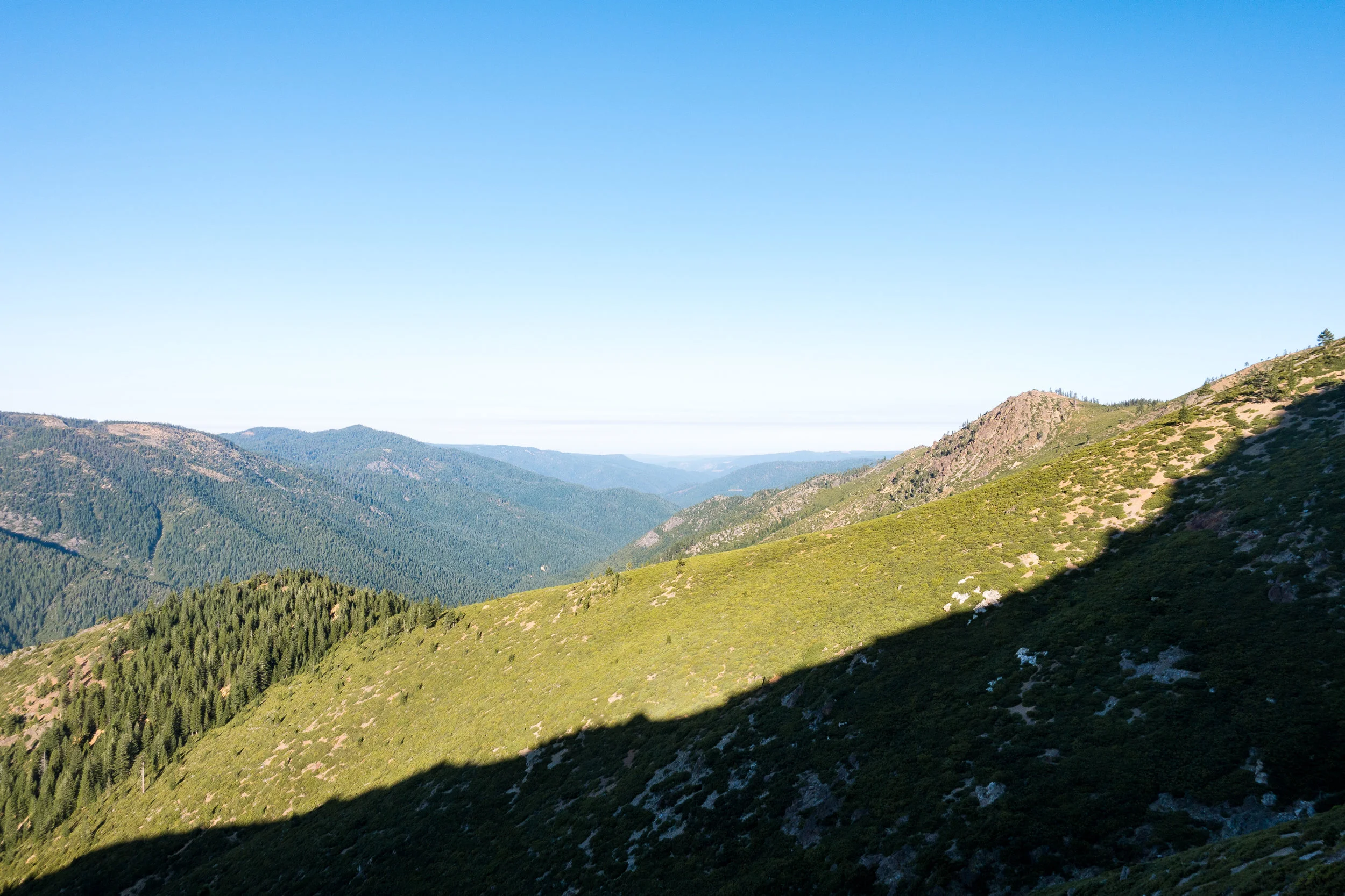 Hiking in the shade of the mountain before the sun gets too high up above.