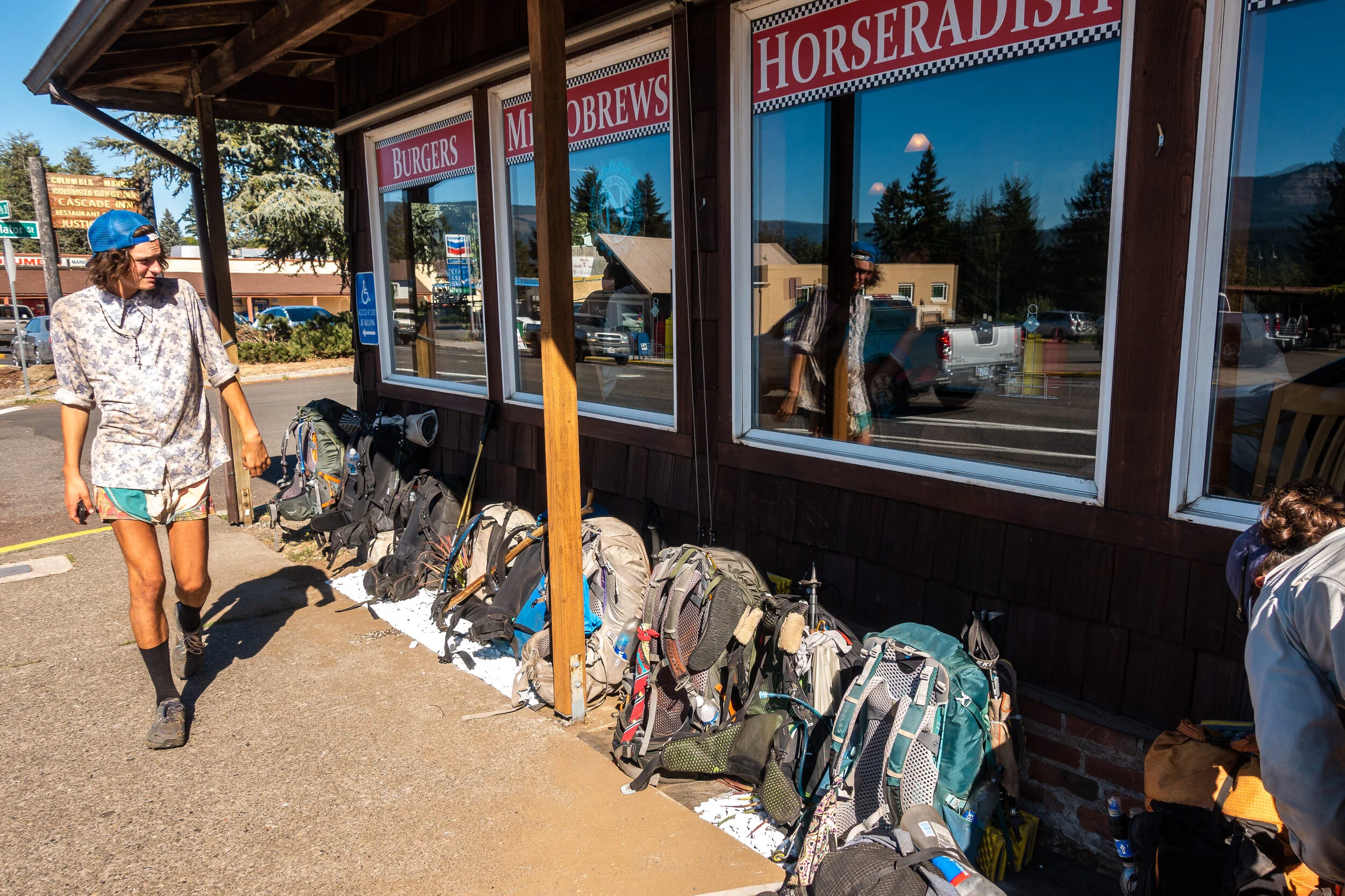 Sam and a pile of backpacks.