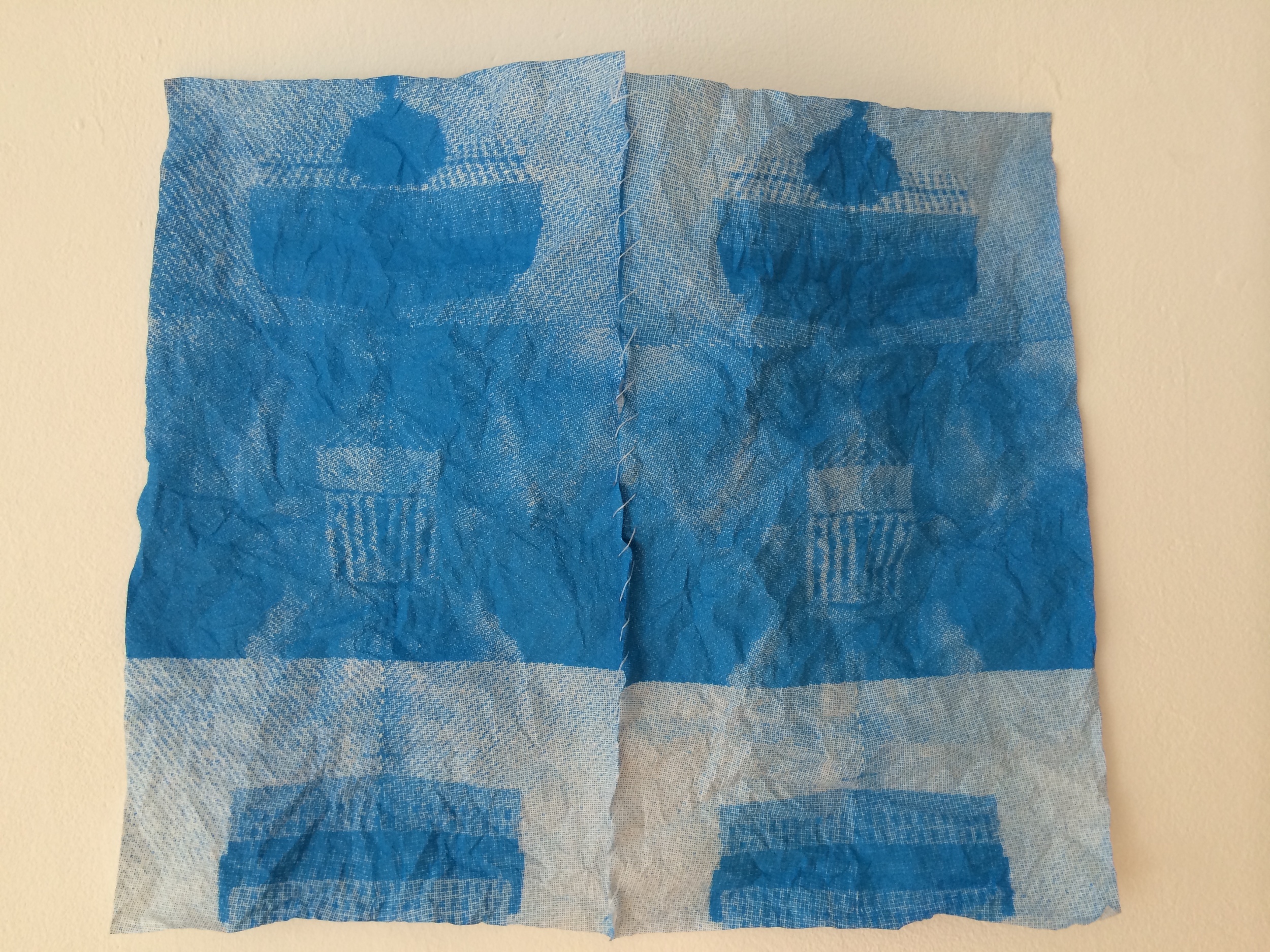 8/25 Screen prints on paper napkins, sewn together and crumpled.