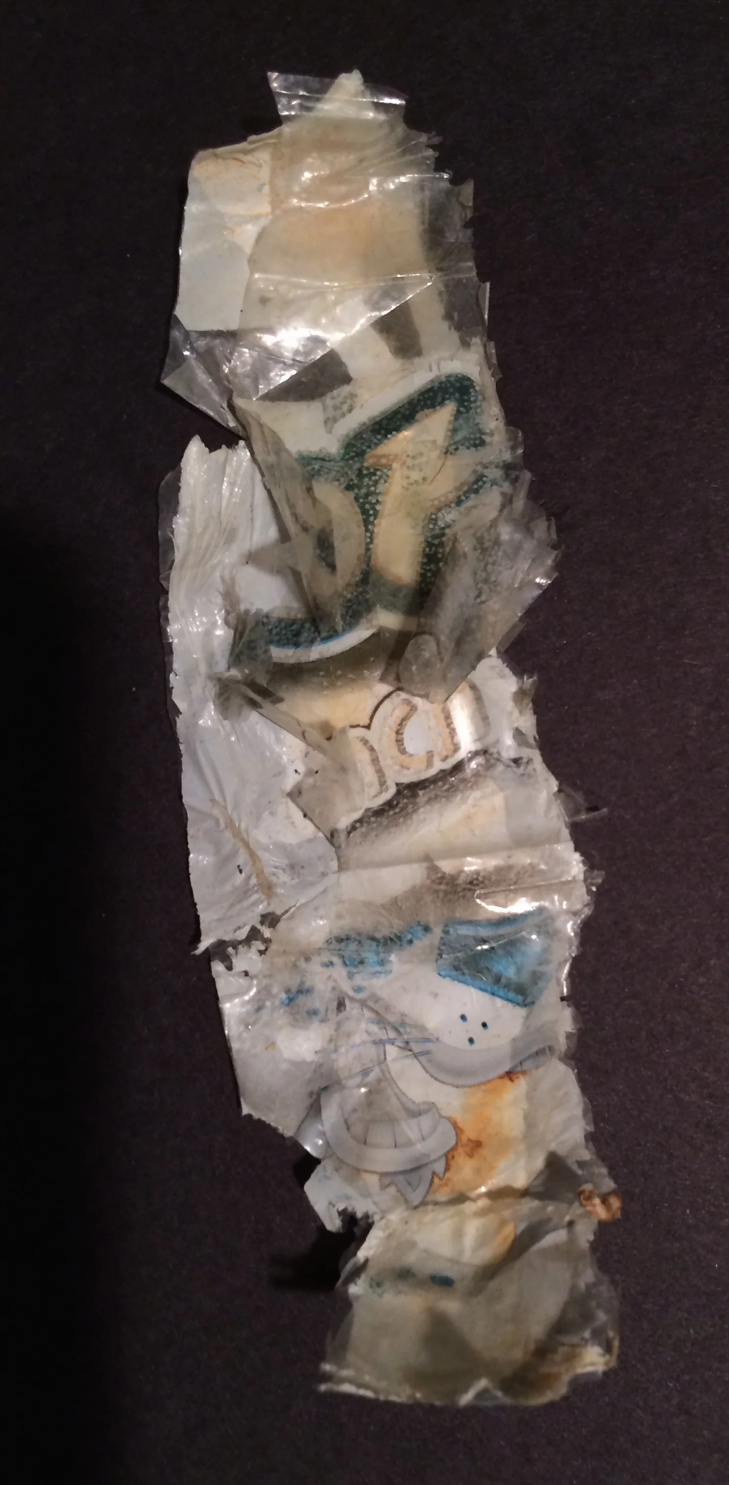 By my count, this Cheetos bag has separated into a trifecta of plastic films - the mylar-like silver lining, the once colorful plastic printed layer, and the clear top layer. 