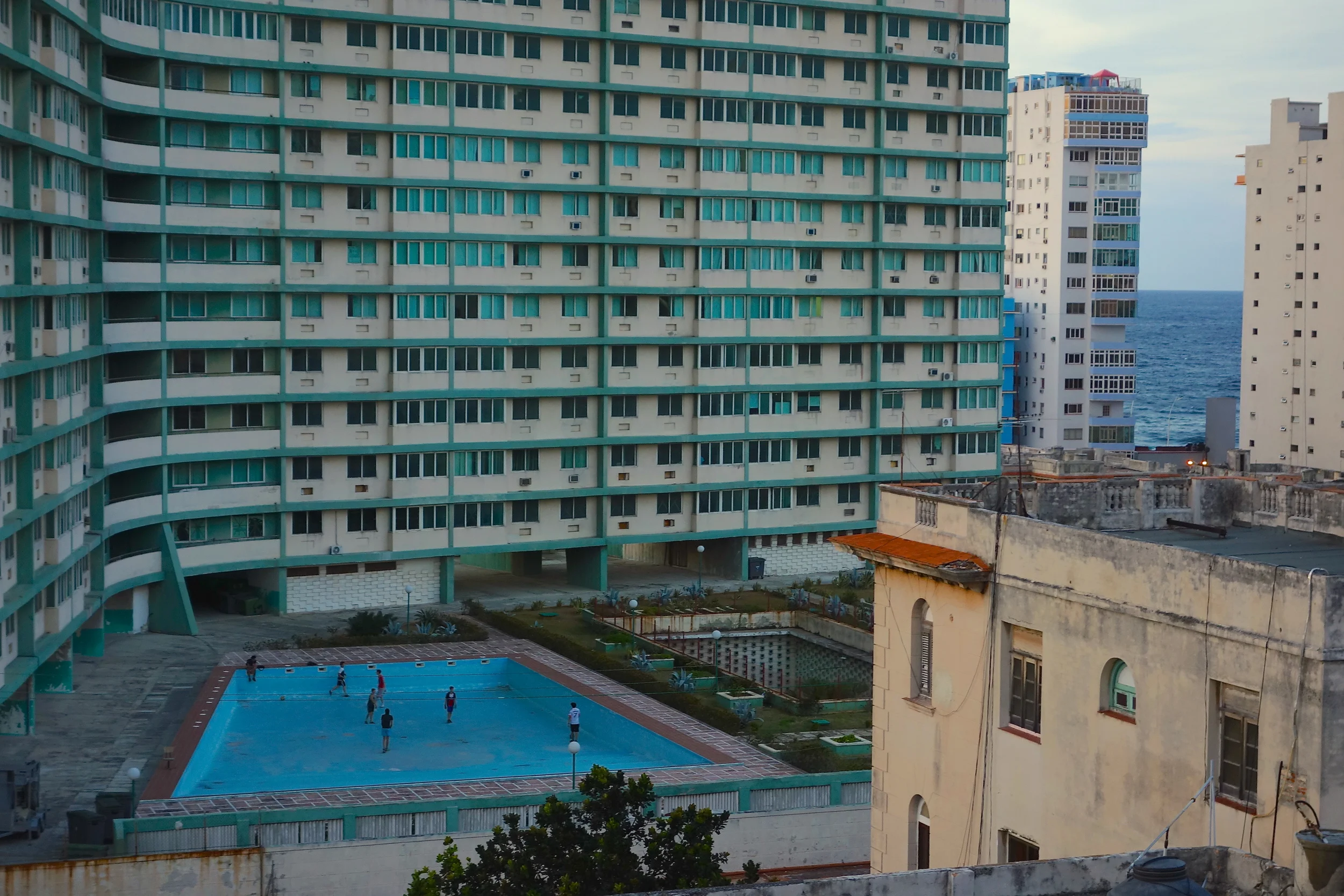  Our view from Cafe Laurent: Kids play soccer in the empty pool of the Riviera Havana, a ghost of the mid-century glamour that once defined Havana.&nbsp; 
