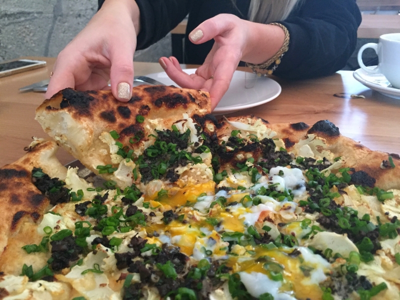 Black & White pizza topped with an egg. ( Photo by Nicole Urso Reed. )
