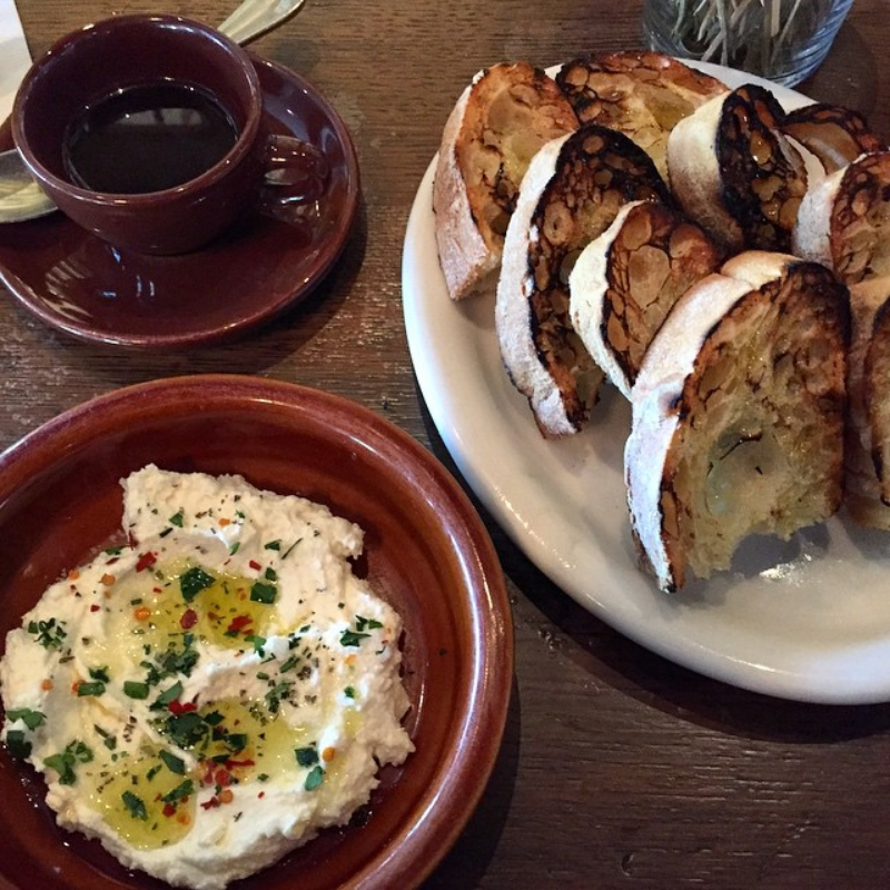 Essential starter: Fresh ricotta and herbs, garlic toasts and a personal pot of espresso. ( Photo by Nicole Urso Reed @lincolnandrose .)