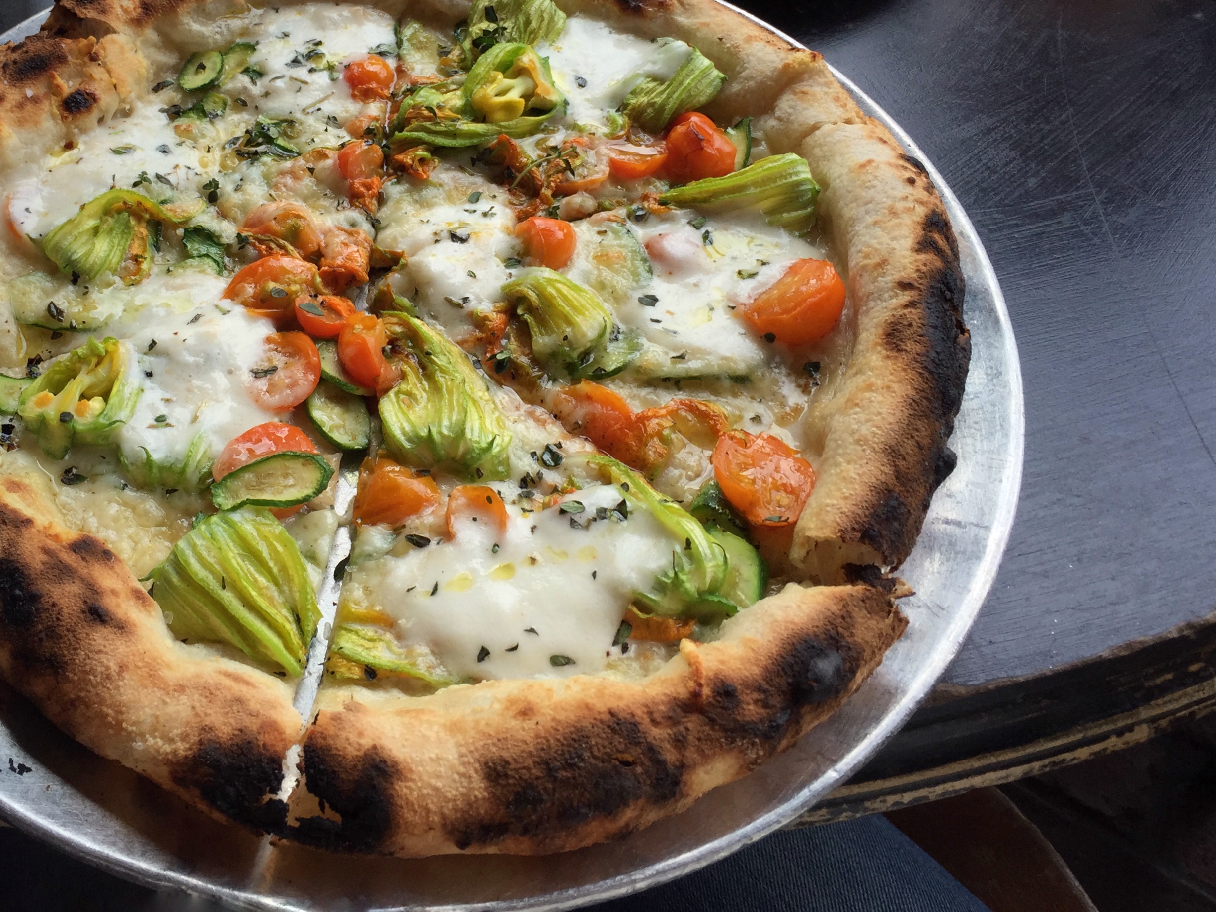 Gjelina's squash blossom pizza with cherry tomatoes, thyme, burrata and Parmesan. ( Photo by Lincoln & Rose )