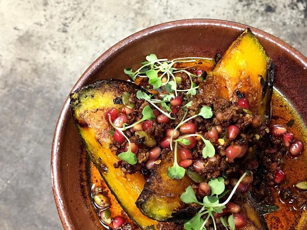 Hearth-roasted pumpkin with chorizo pomegranate salsa and vincoto vinaigrette. ( Photo by The Rose )