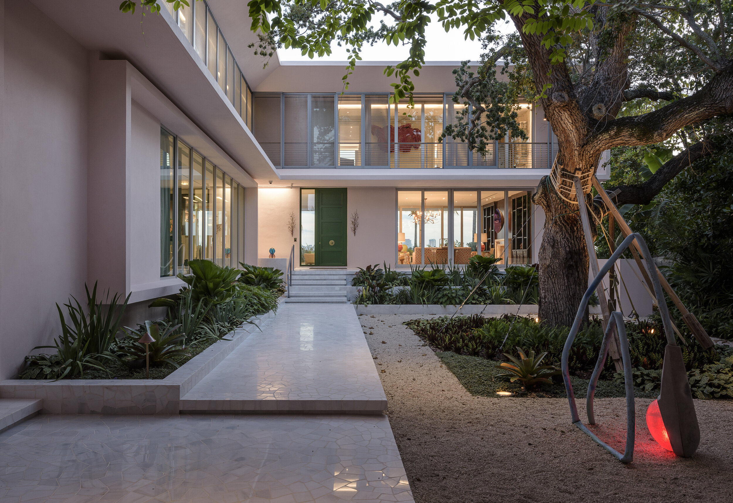  Zaguan and interior courtyard    A procession from the street through an interior courtyard to the front door incorporates several large artworks embedded into the landscape.   