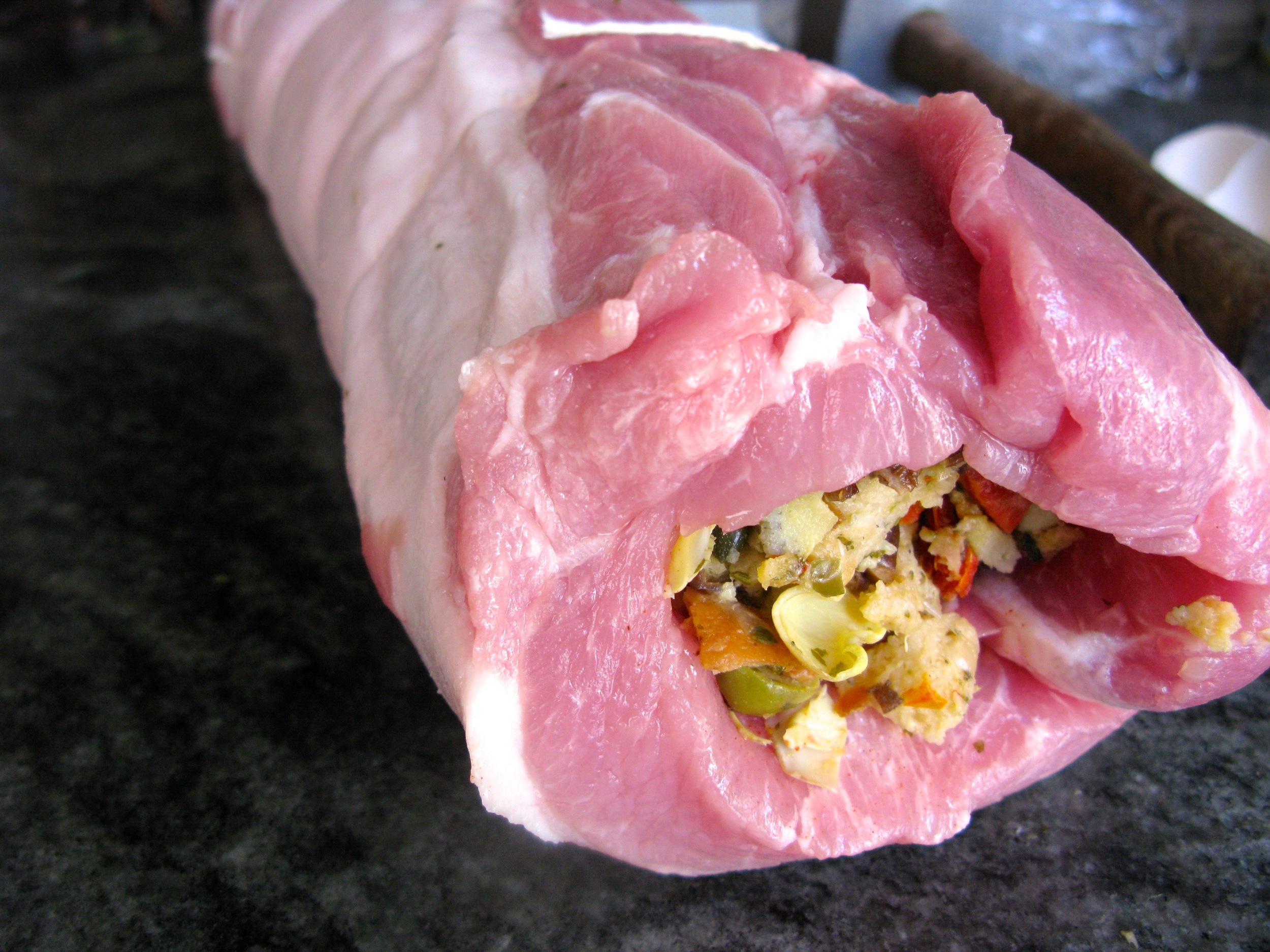 Roll the pork loin around the stuffing and tie with butcher's twine.