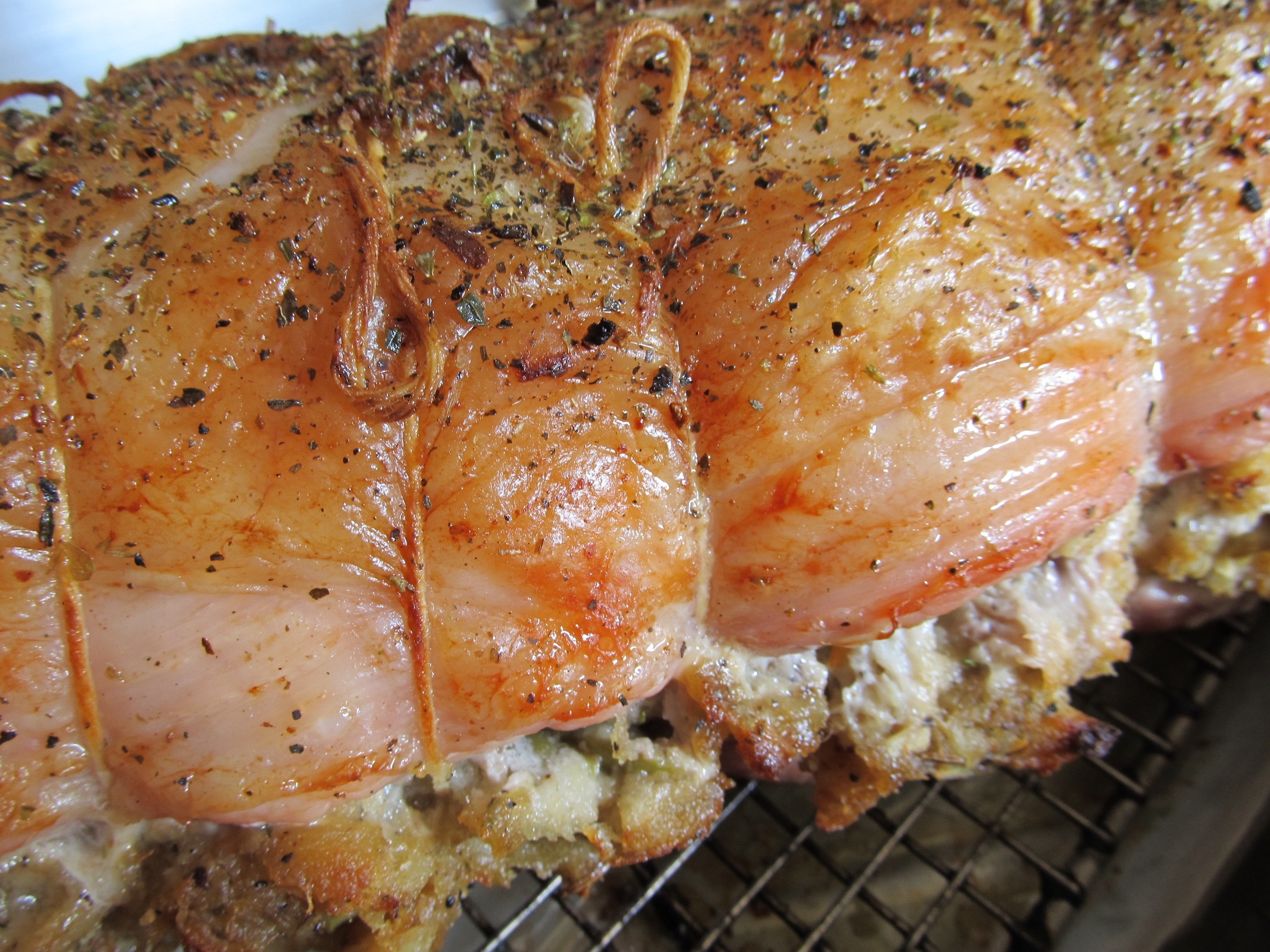 Right out of the oven, a seasoned pork loin is ready to slice.