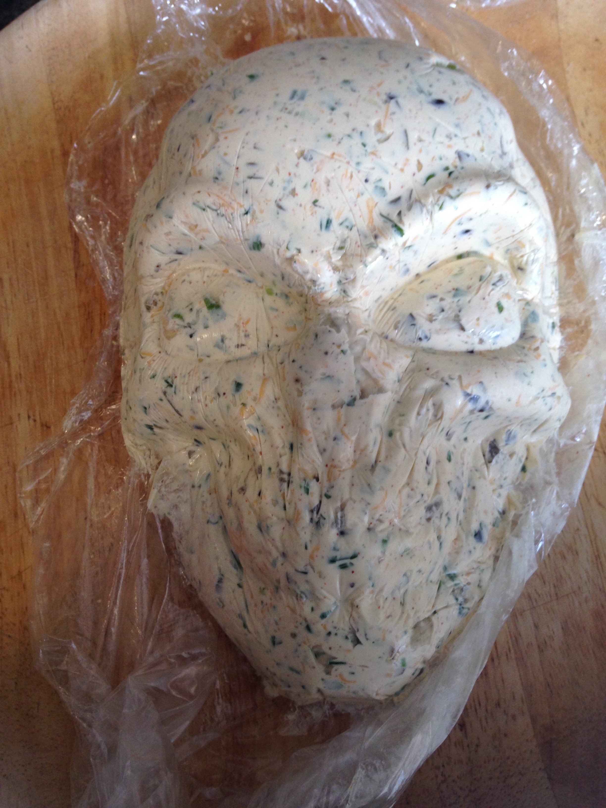 Turn molded cheese mixture onto serving tray and gently remove the plastic wrap.