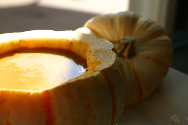 Creamy, smooth Curry Butternut Squash Soup served in hollowed mini pumpkin